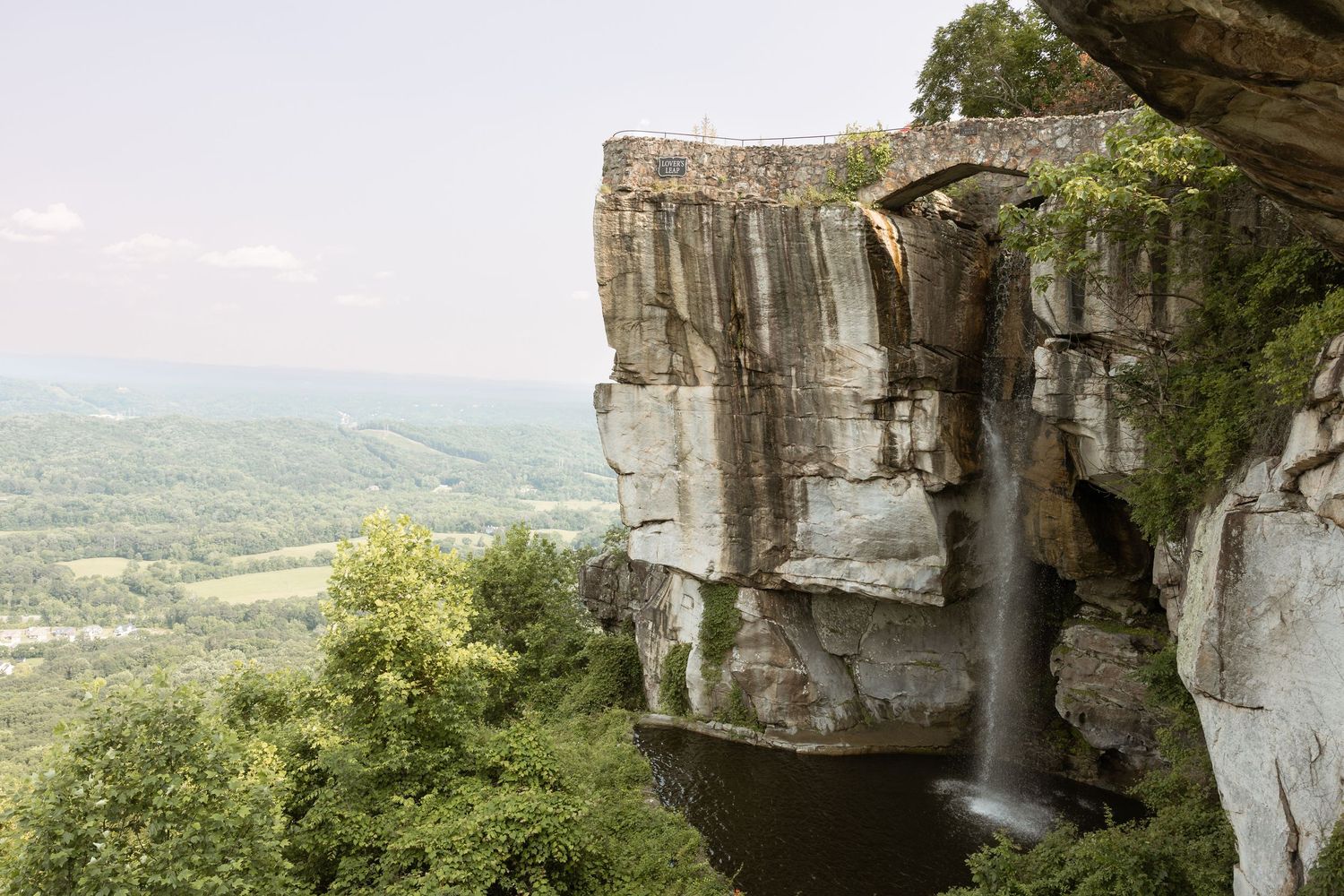 Romantic engagement moment at Rock City Lover’s Leap in Lookout Mountain Georgia
