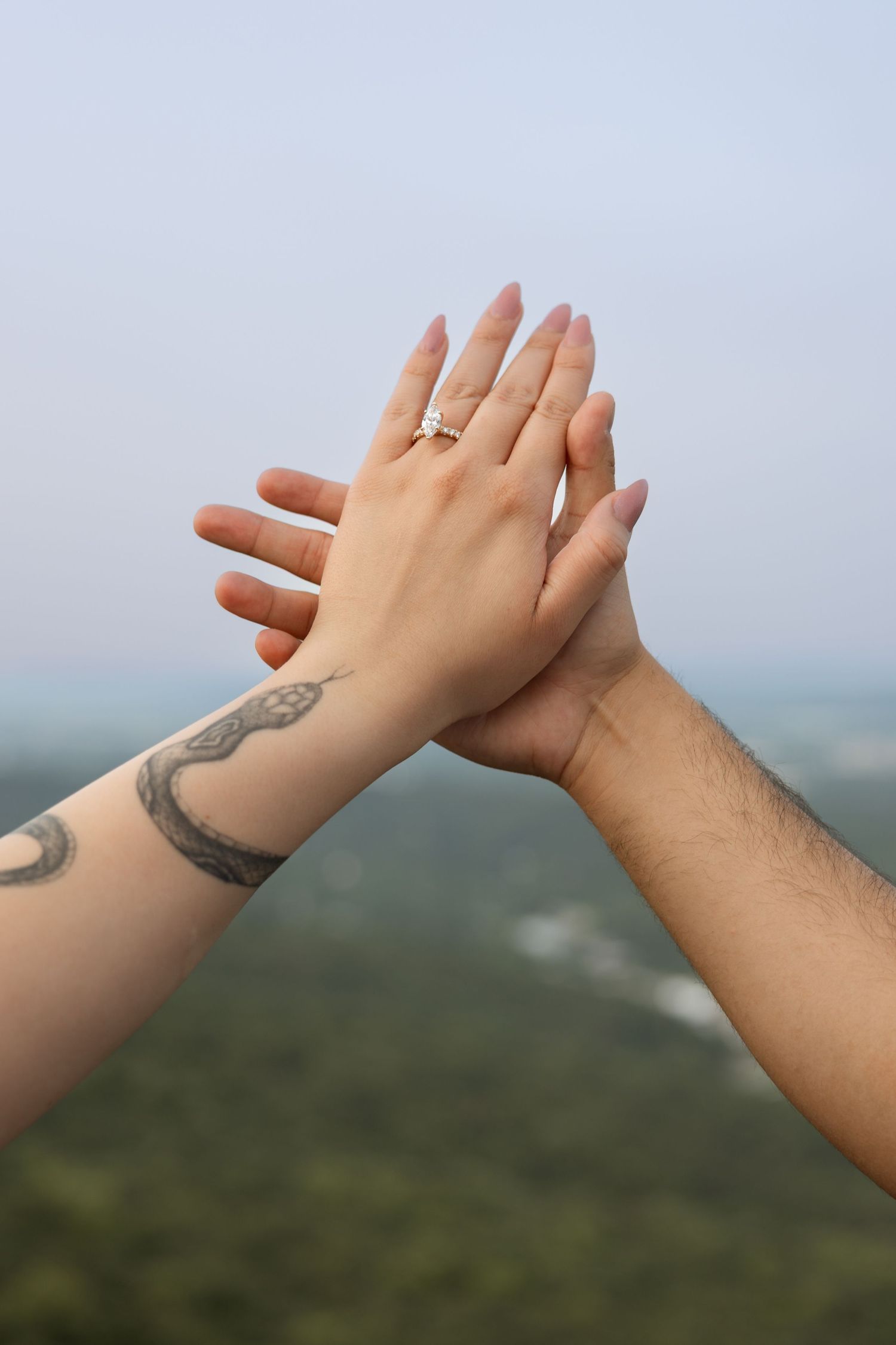 Romantic engagement portraits of couple at Rock City Lover’s Leap overlook in North Georgia