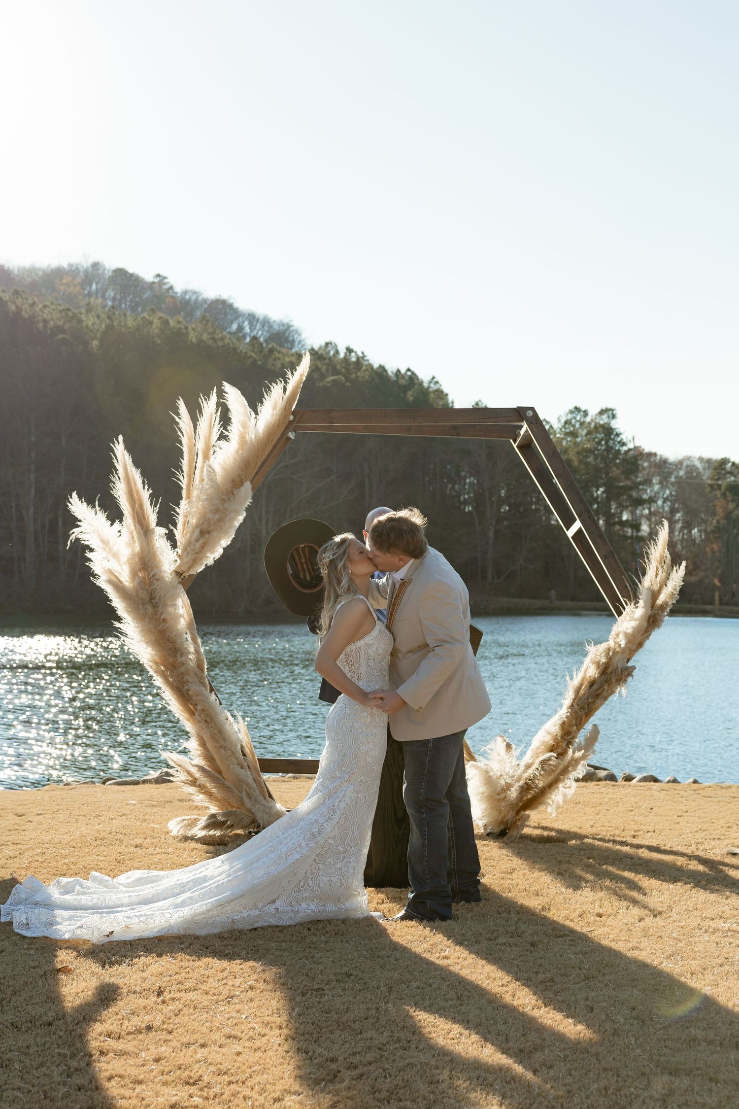 Bride and groom exchanging vows at Taylor Estate lakefront ceremony in Rome Georgia during late fall wedding