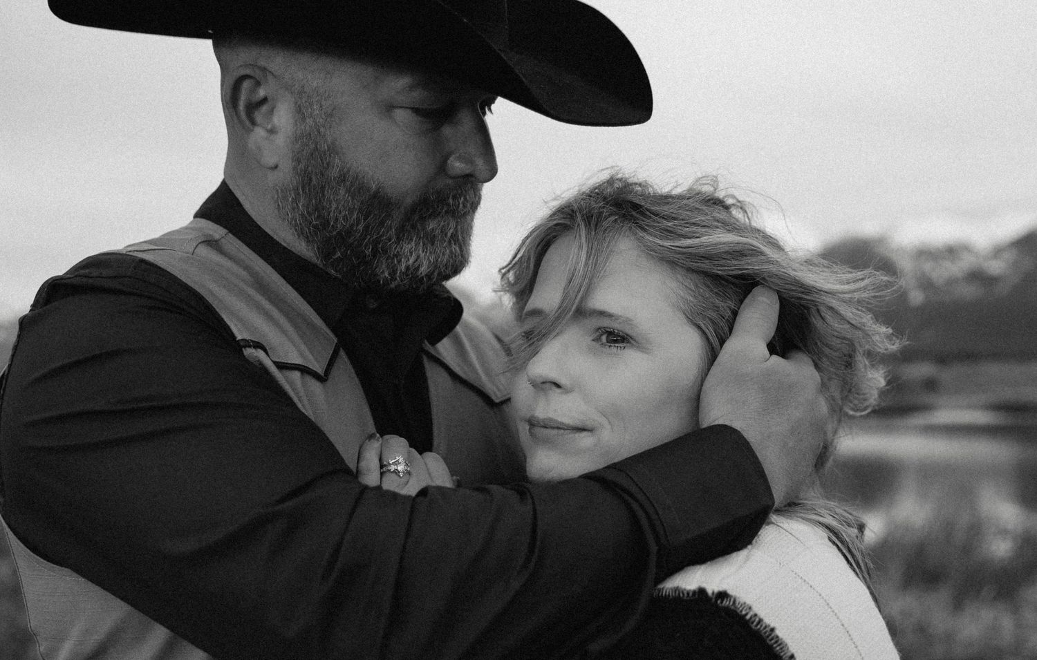 A romantic black and white photo series showing intimate moments between a couple in western attire.