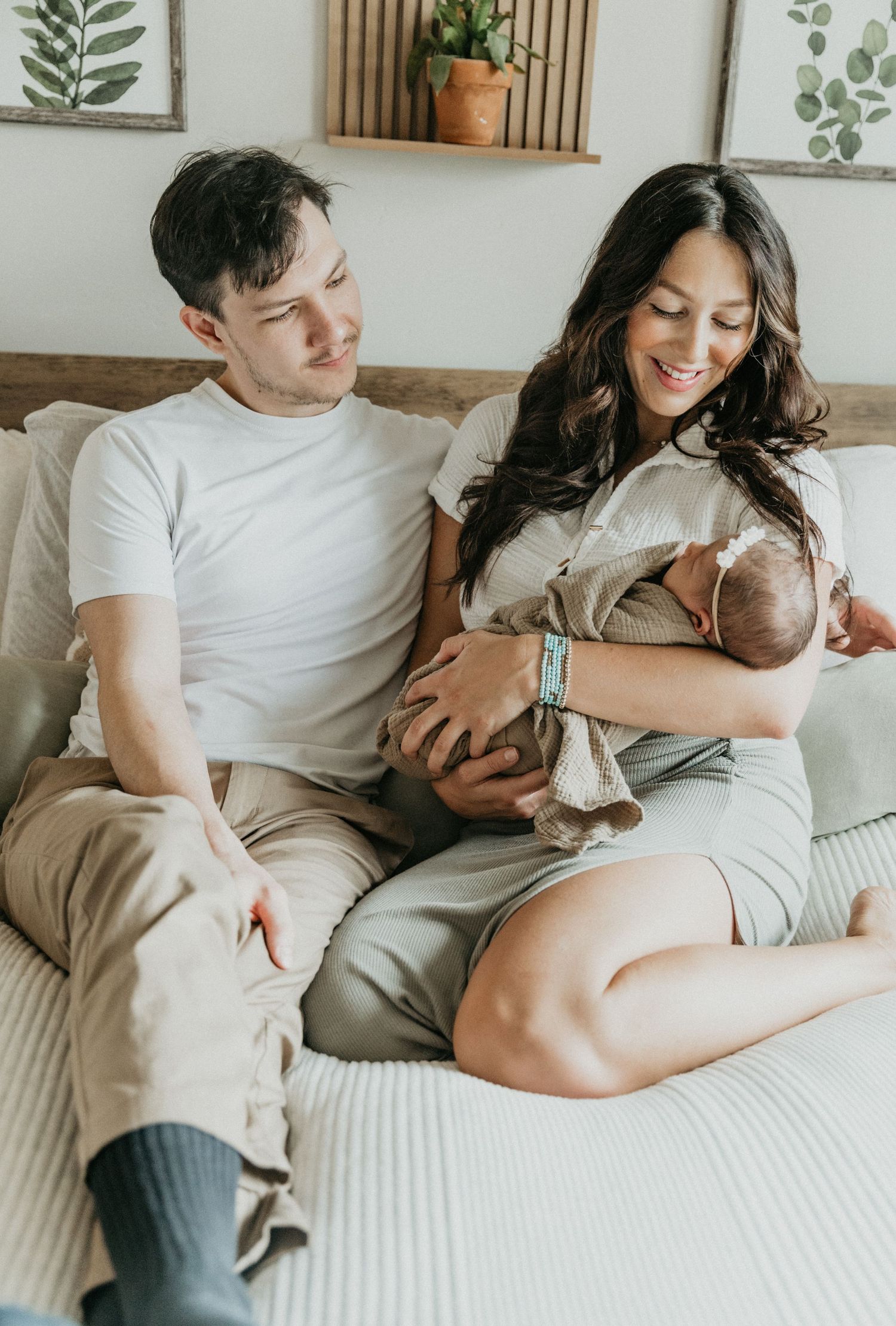a new family of three shares smiles and cuddles during their in home session