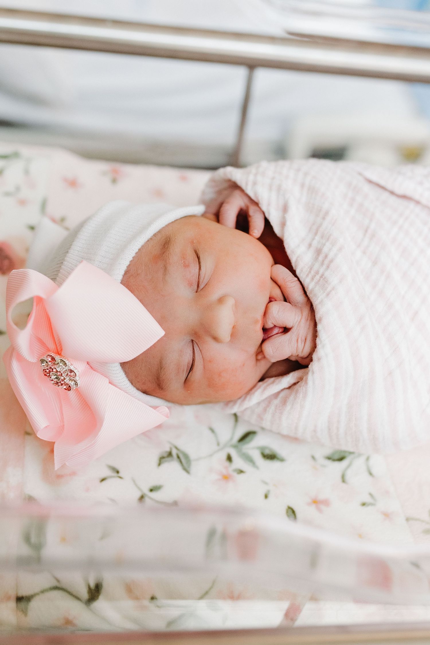 a sweet newborn girl sucks on her tiny fingers during her fresh 48 session