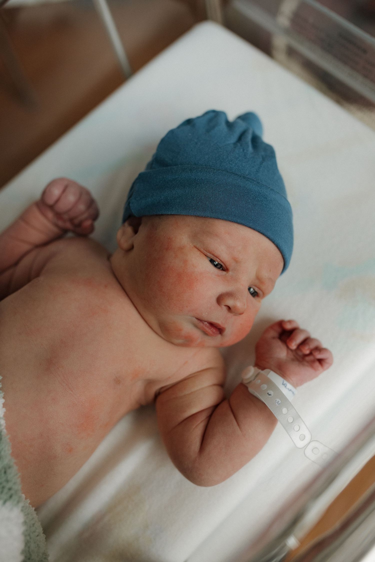 a newborn baby is curious and looking around during his fresh 48 session