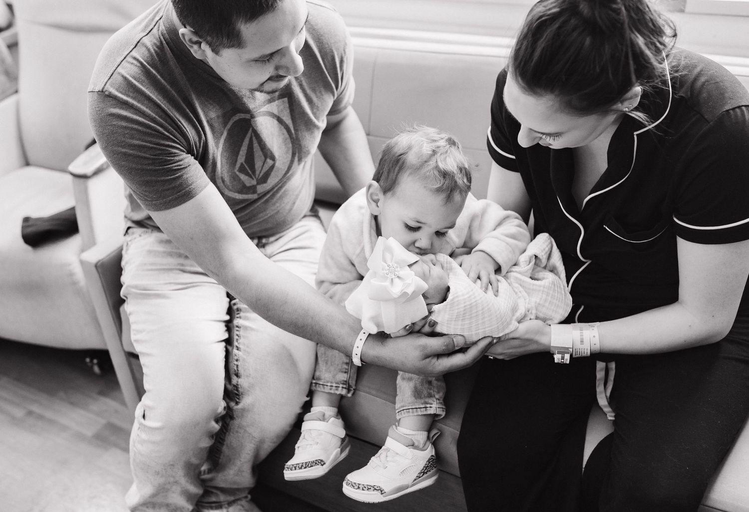 a sweet family introducing big brother to baby sister during this fresh 48 session