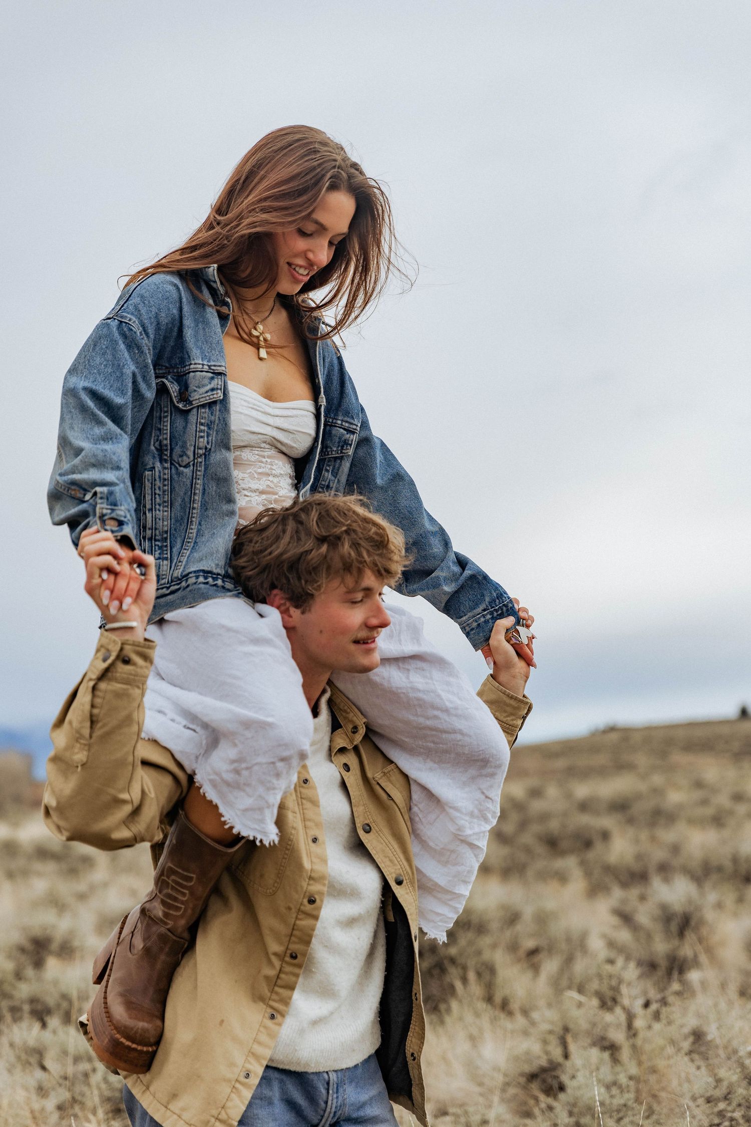 A playful piggyback ride moment captured in the mountain wilderness.