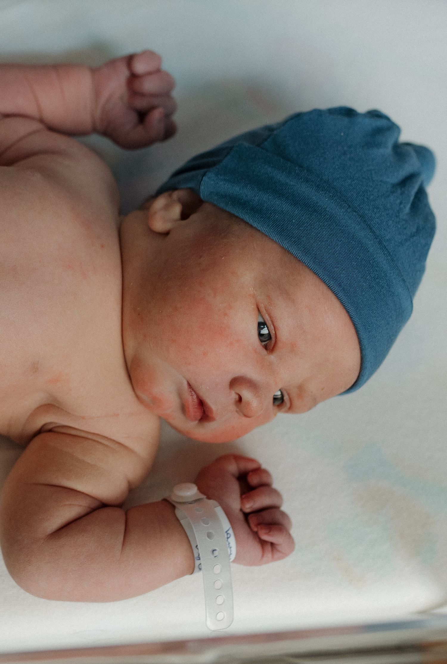 a newborn baby is curious and looking around during his fresh 48 session
