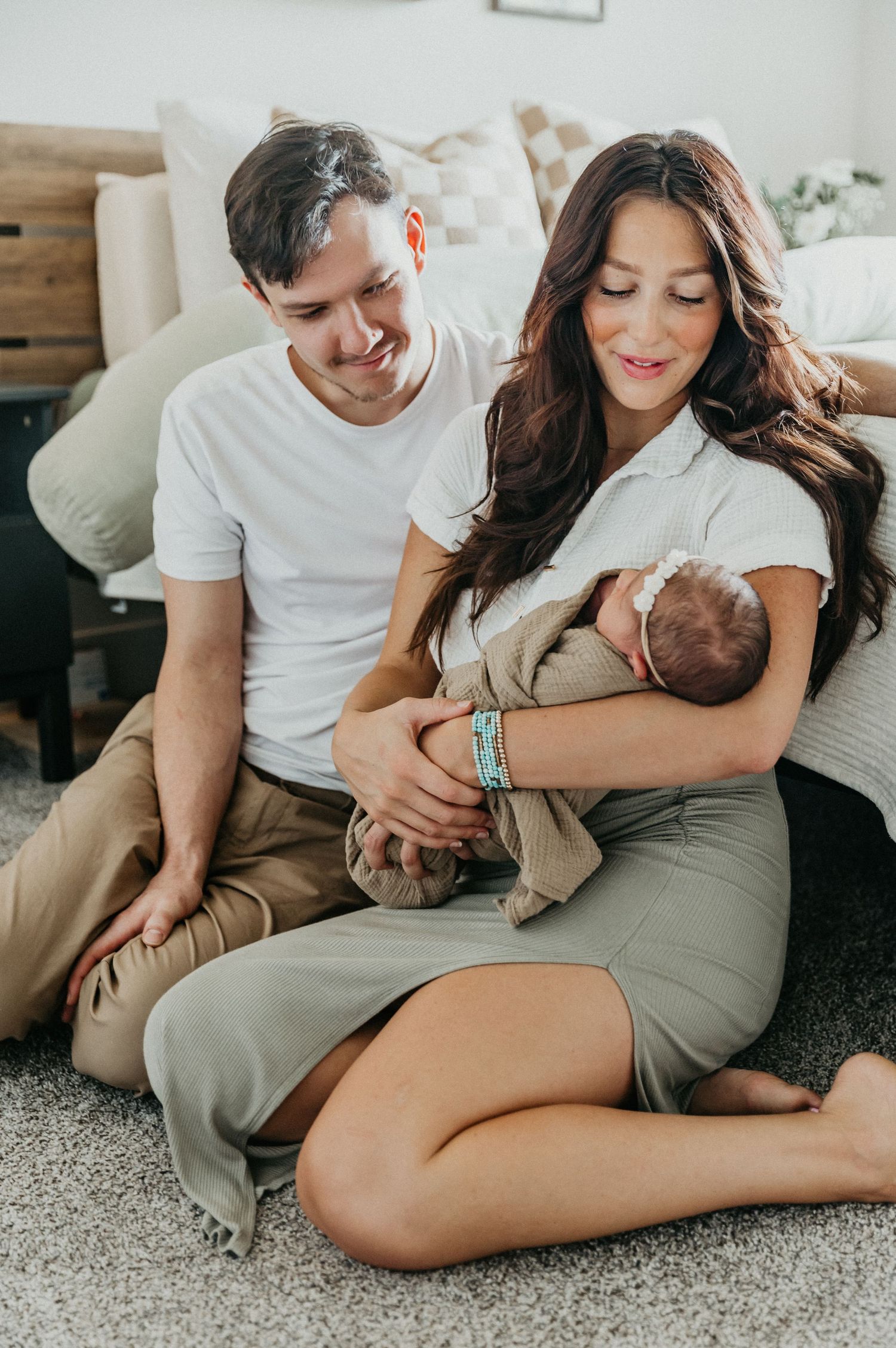 a new family of three shares smiles and cuddles during their in home session