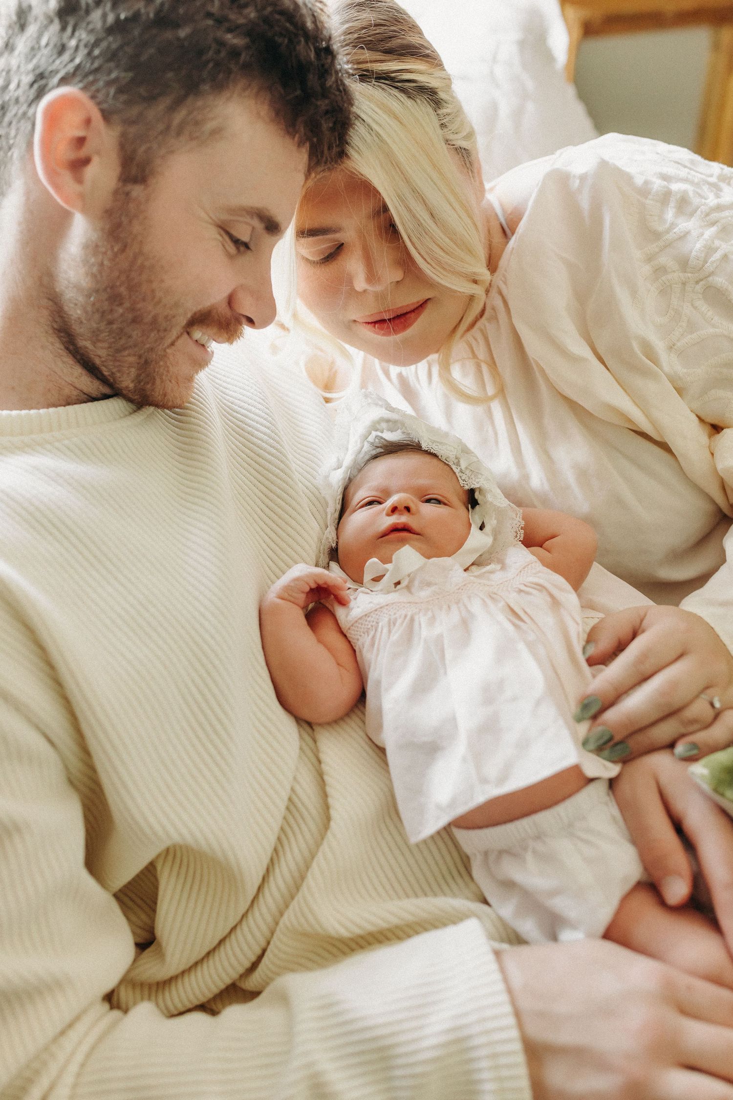 a new family of three shares smiles and cuddles during their in home session- nostalgic, vintage inspired.