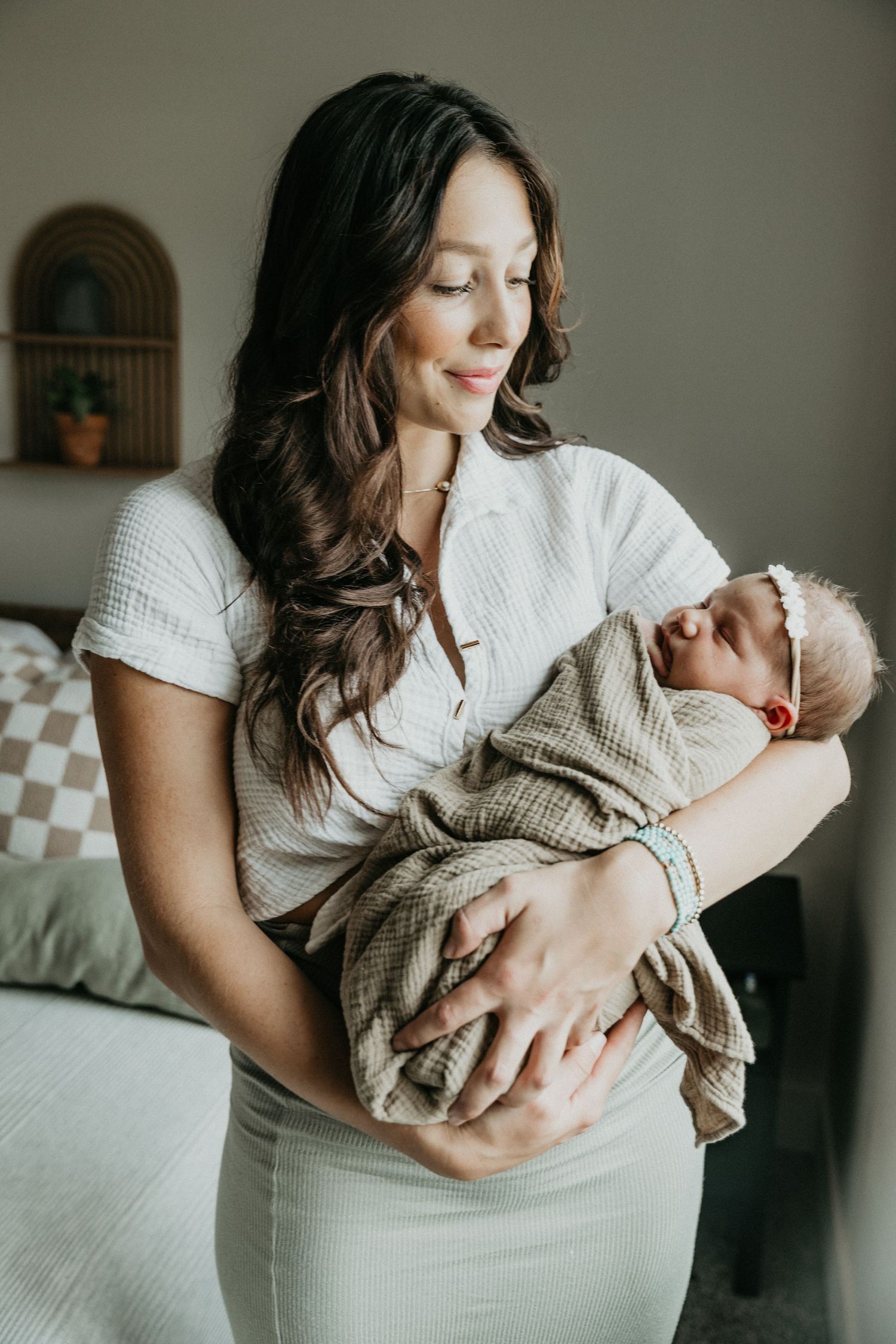 A tender moment between parent and newborn baby in a peaceful home setting.