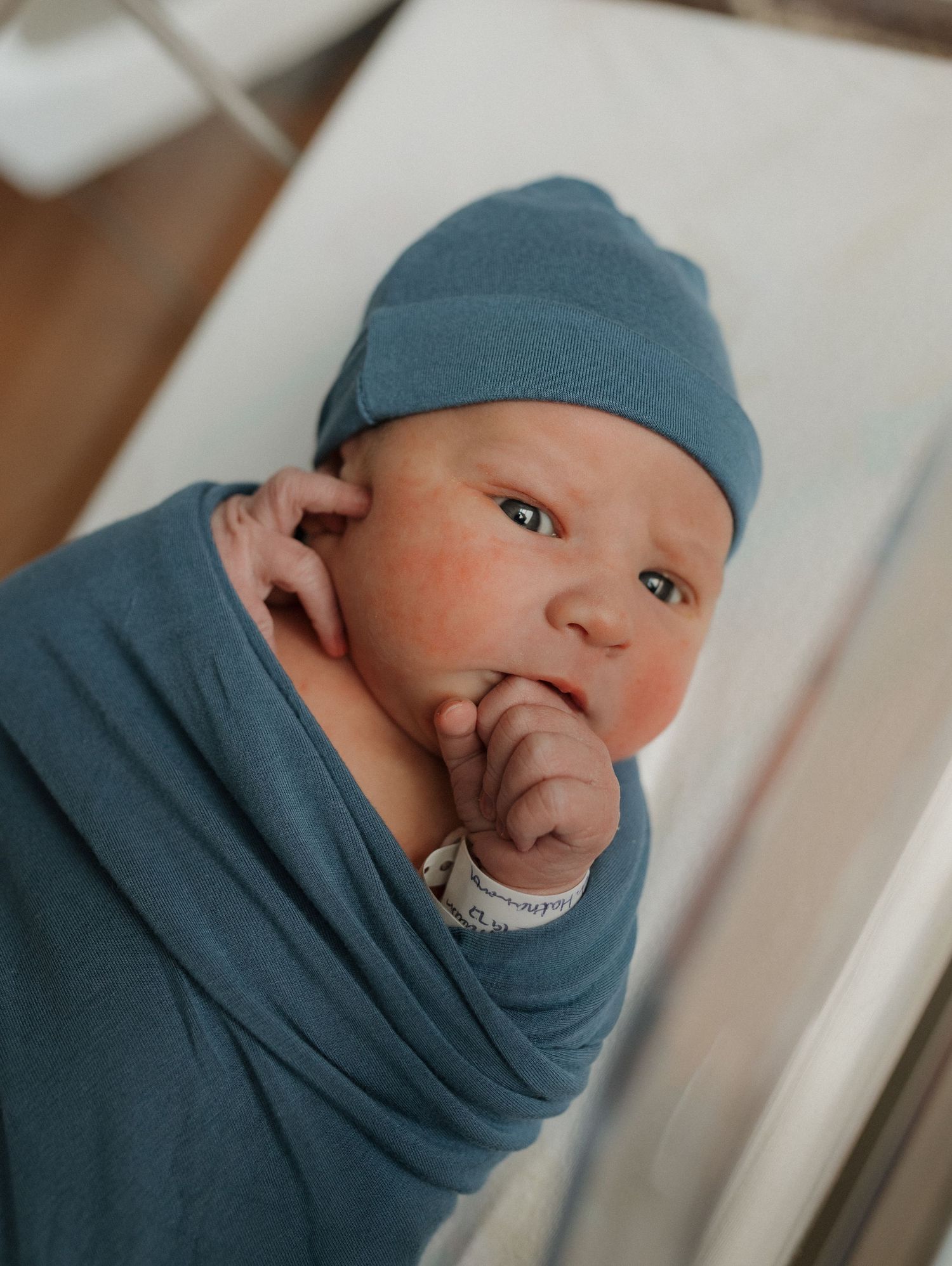a newborn baby is curious and looking around during his fresh 48 session