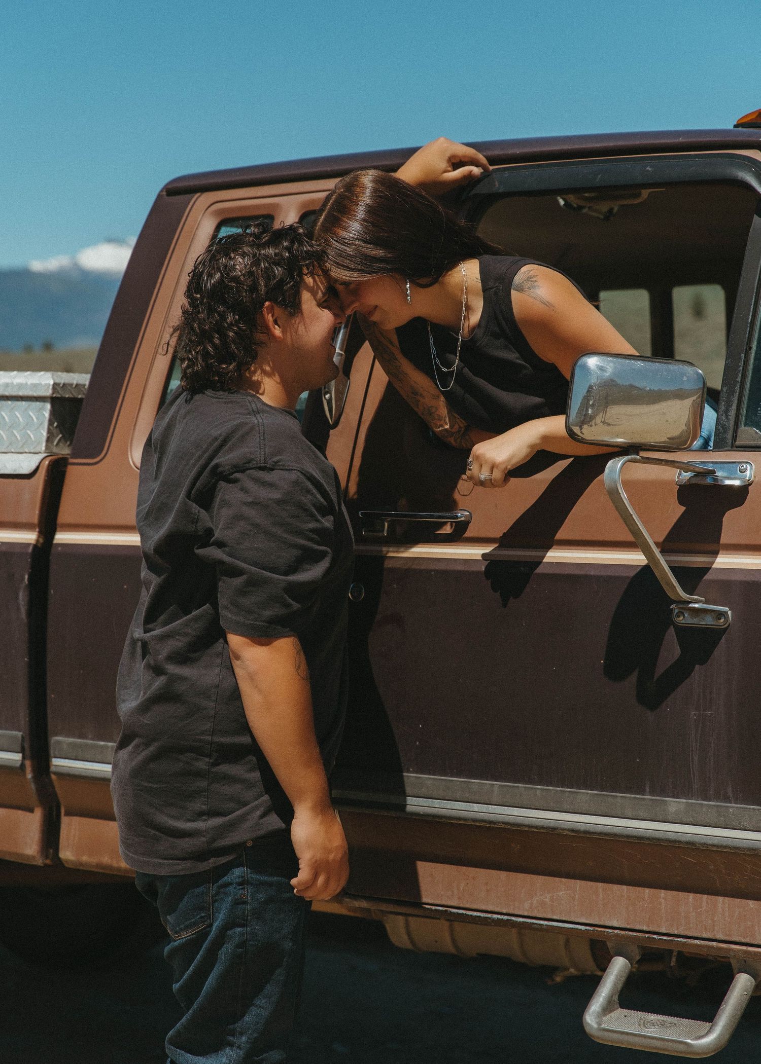 A series of images showing someone opening the door of a brown pickup truck from different angles.