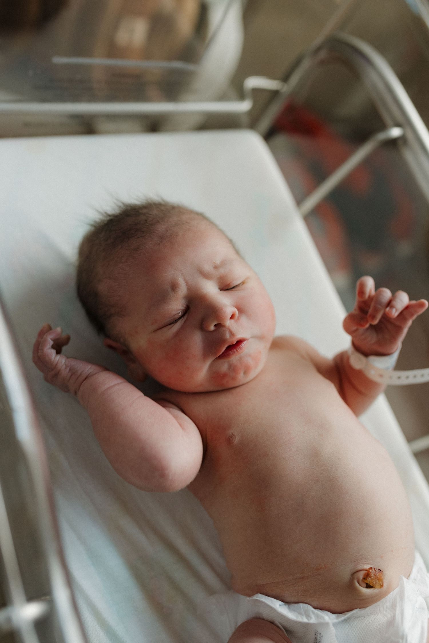 a newborn baby is curious and looking around during his fresh 48 session