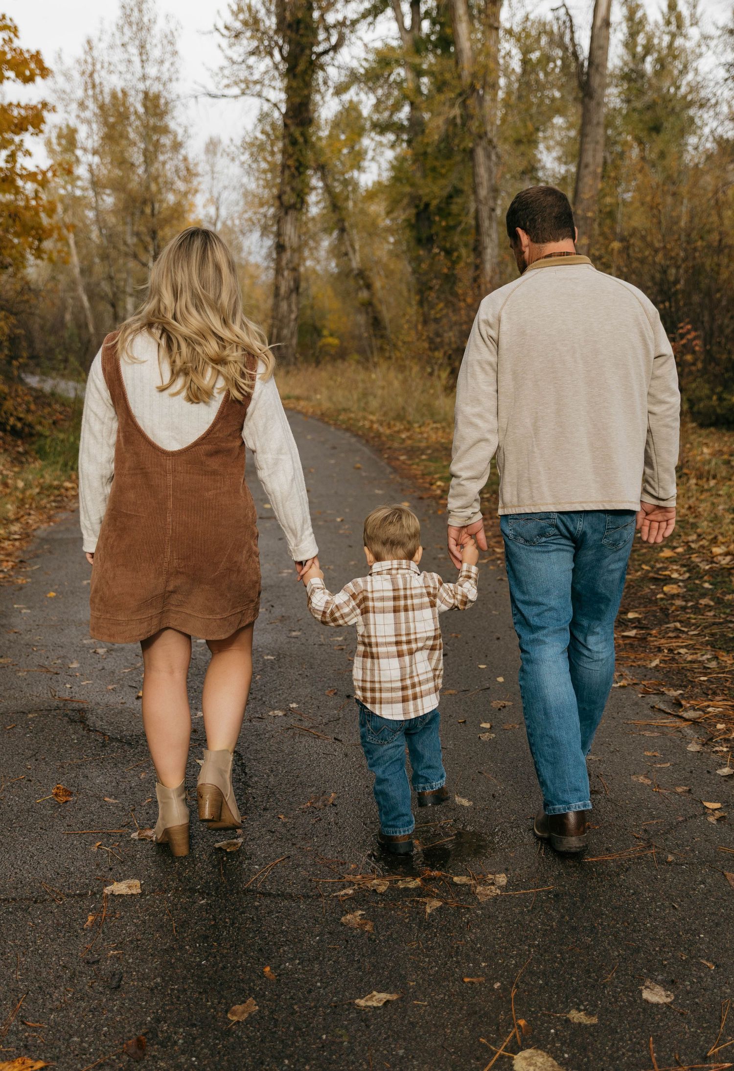 A series of photos showing a family walking together on a leaf-covered path during autumn.