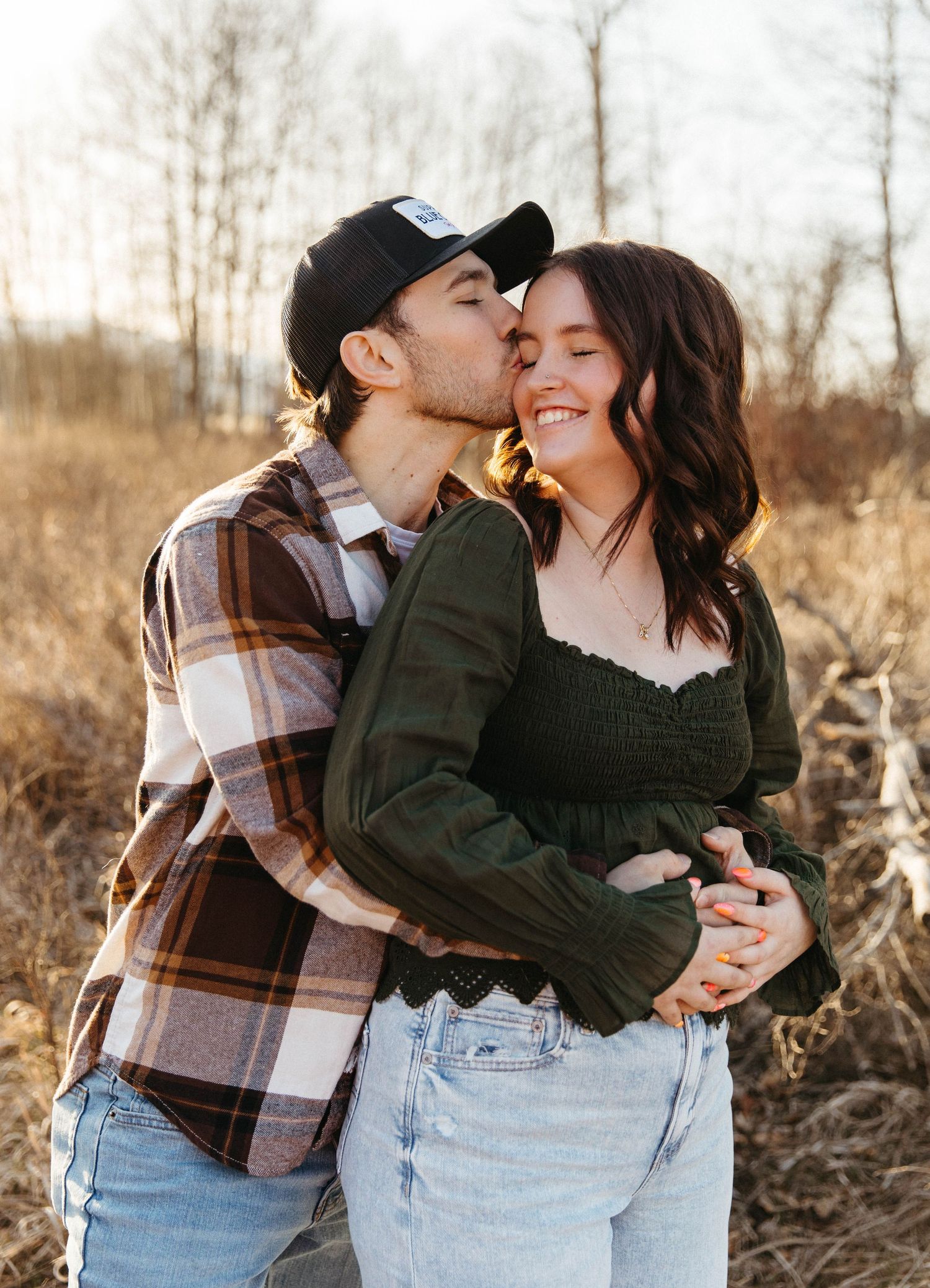 A sweet candid moment between a couple outdoors in autumn light.