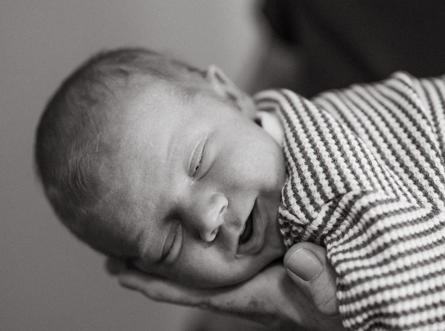 Monochrome series showing a sleeping baby in striped clothing.