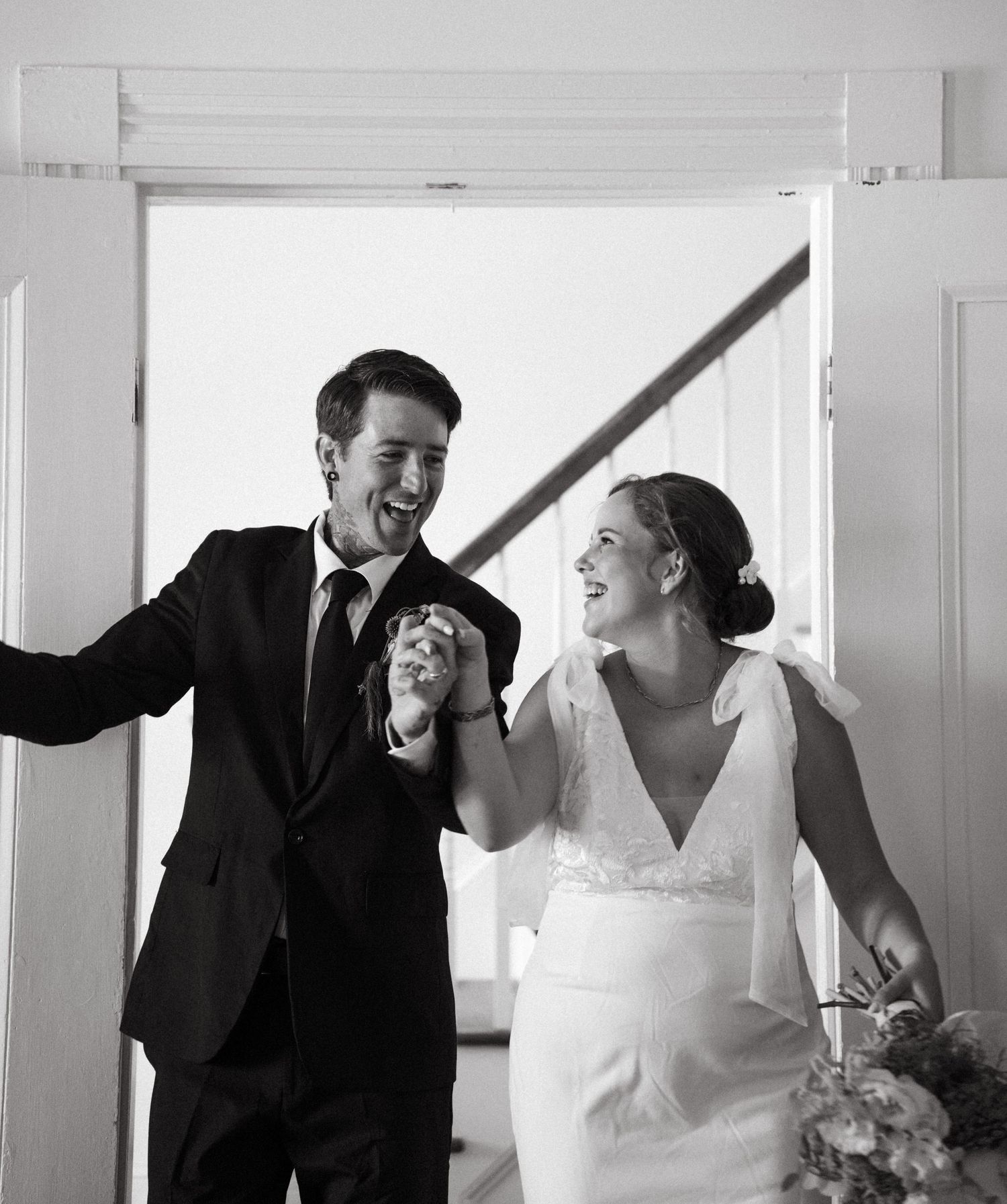 Black and white photo series showing a happy couple laughing and embracing during their wedding photoshoot.