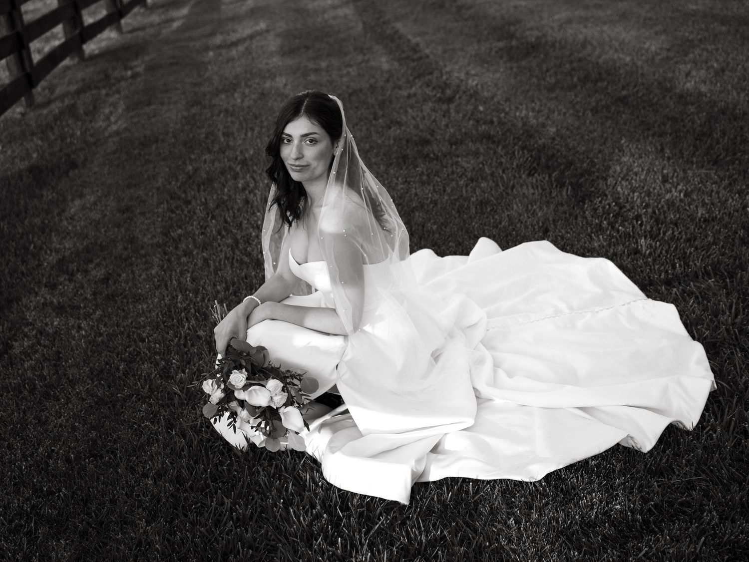A series of black and white artistic bridal portraits showing a woman in a flowing white dress laying on grass.