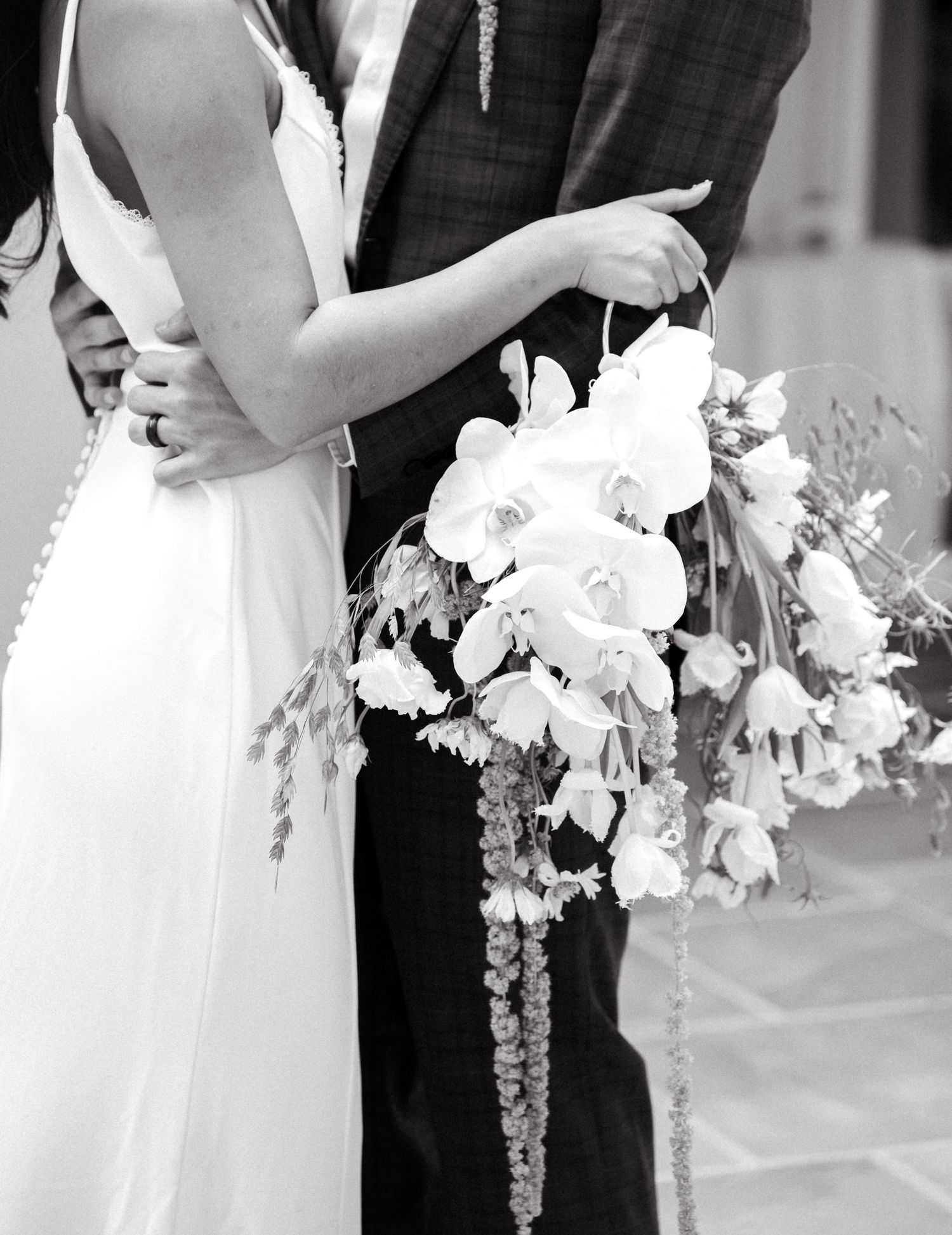 Black and white photo series showing couple with cascading white bouquet in formal attire.