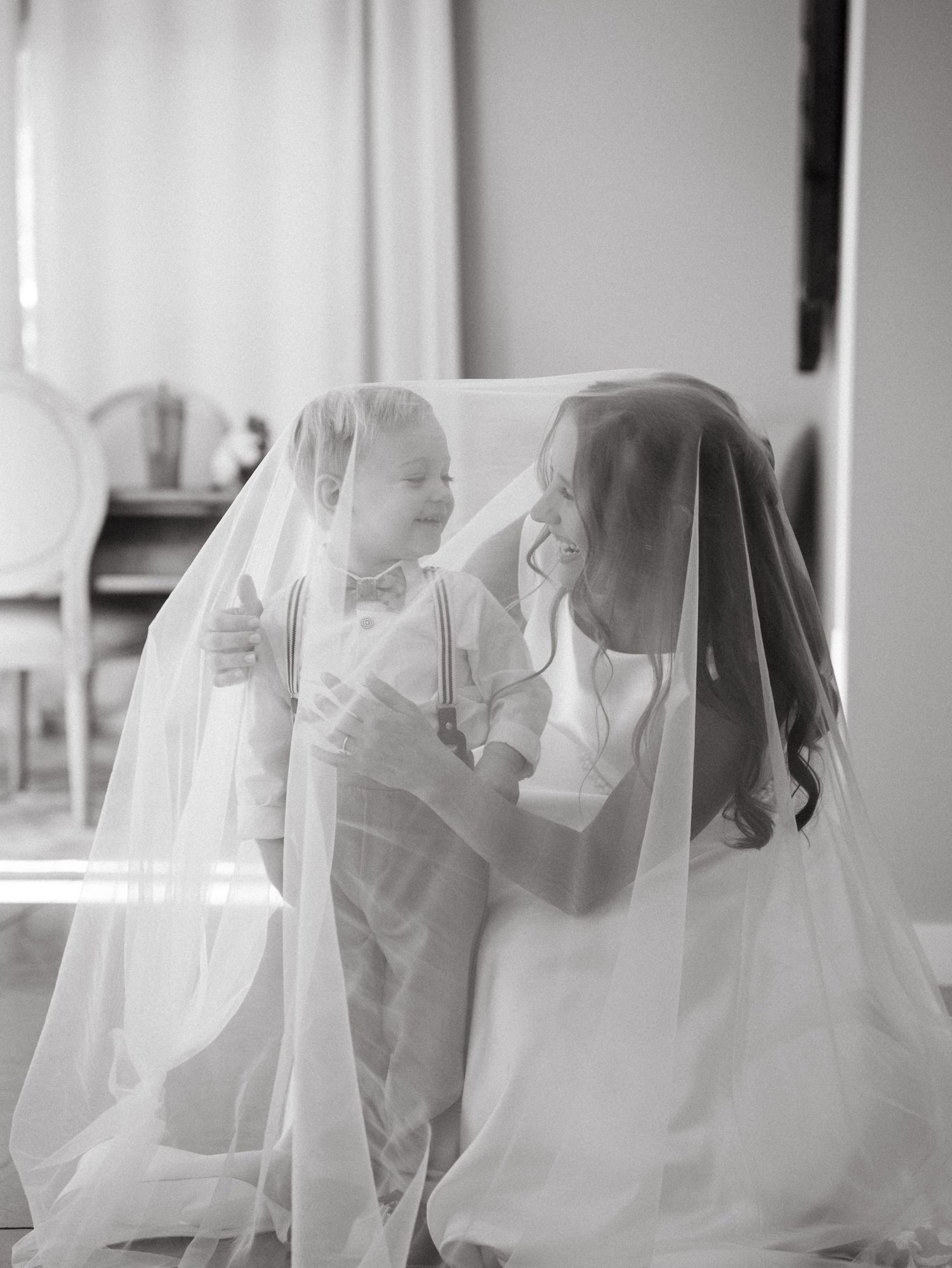 A romantic black and white sequence shows a bride and groom sharing an intimate moment under a flowing veil.