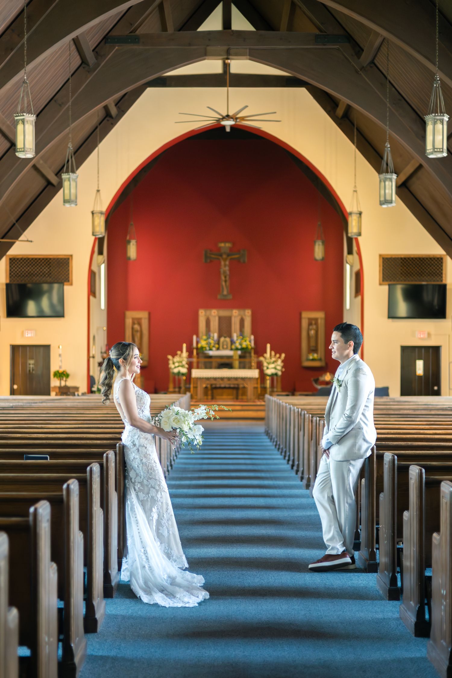 A sequence of wedding photos showing a couple in white attire posing dramatically in a church aisle with blue carpet.