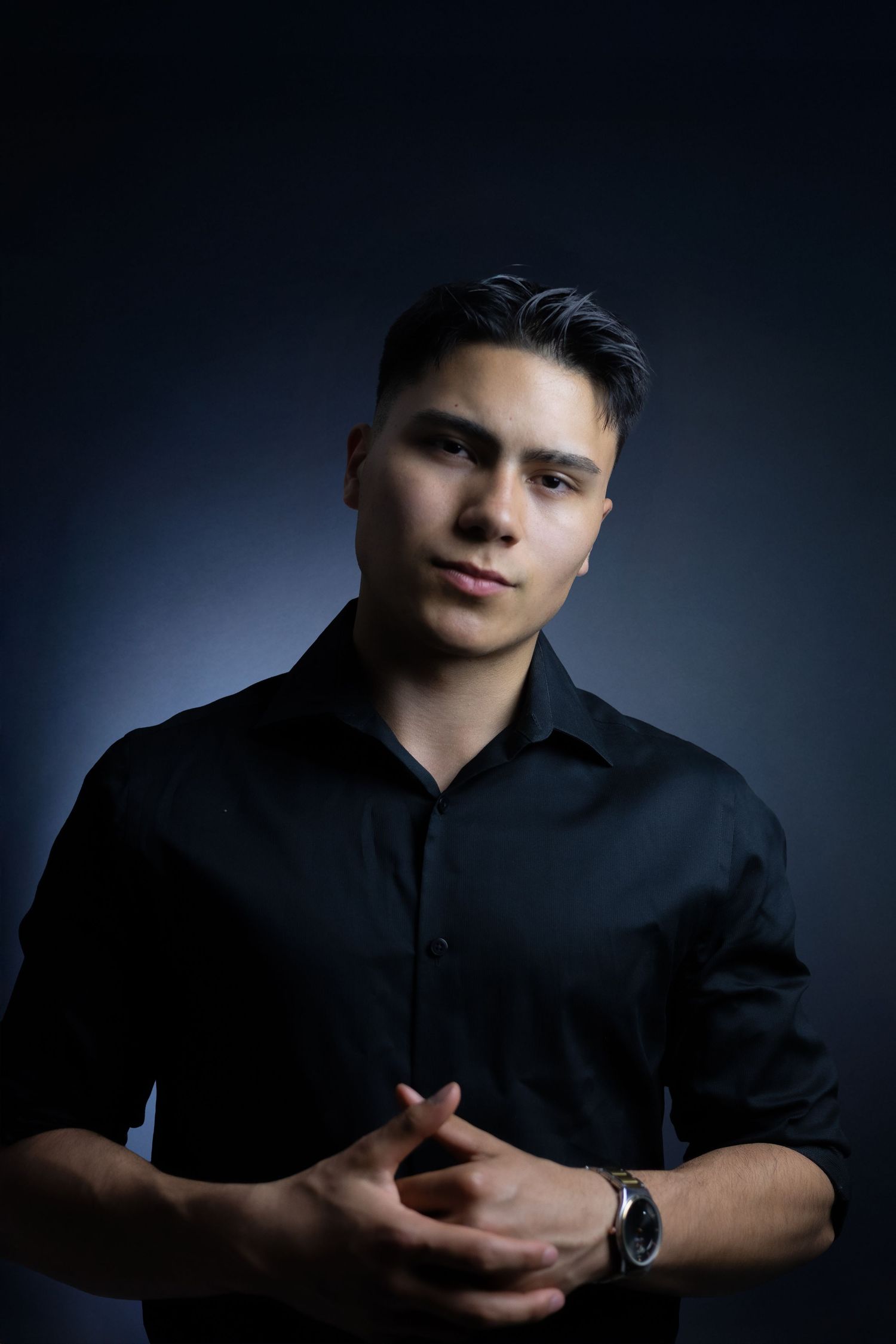 A series of moody dramatic portrait shots against dark background shows someone wearing a black shirt in different poses.