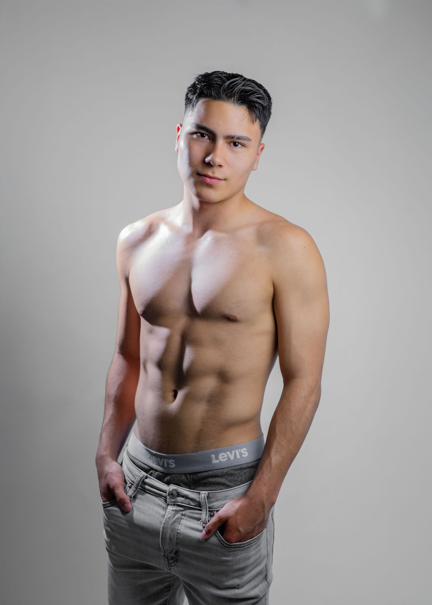 Shirtless man wearing gray Levi's jeans poses against neutral background in modeling headshots collage.