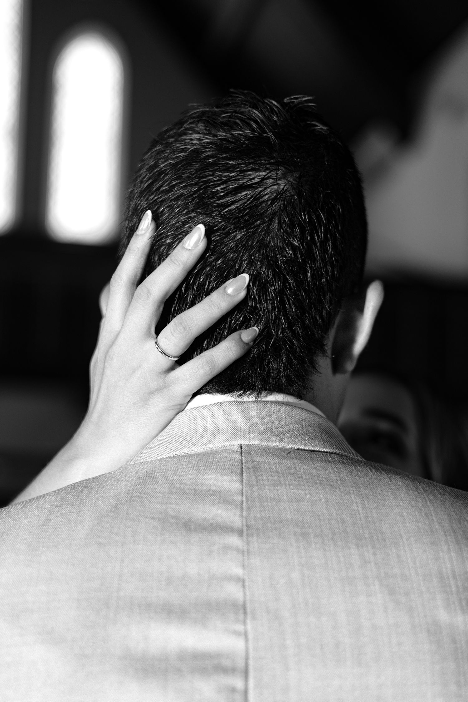 A black and white image sequence showing the back of someone's head and hand in progressive closeup shots.