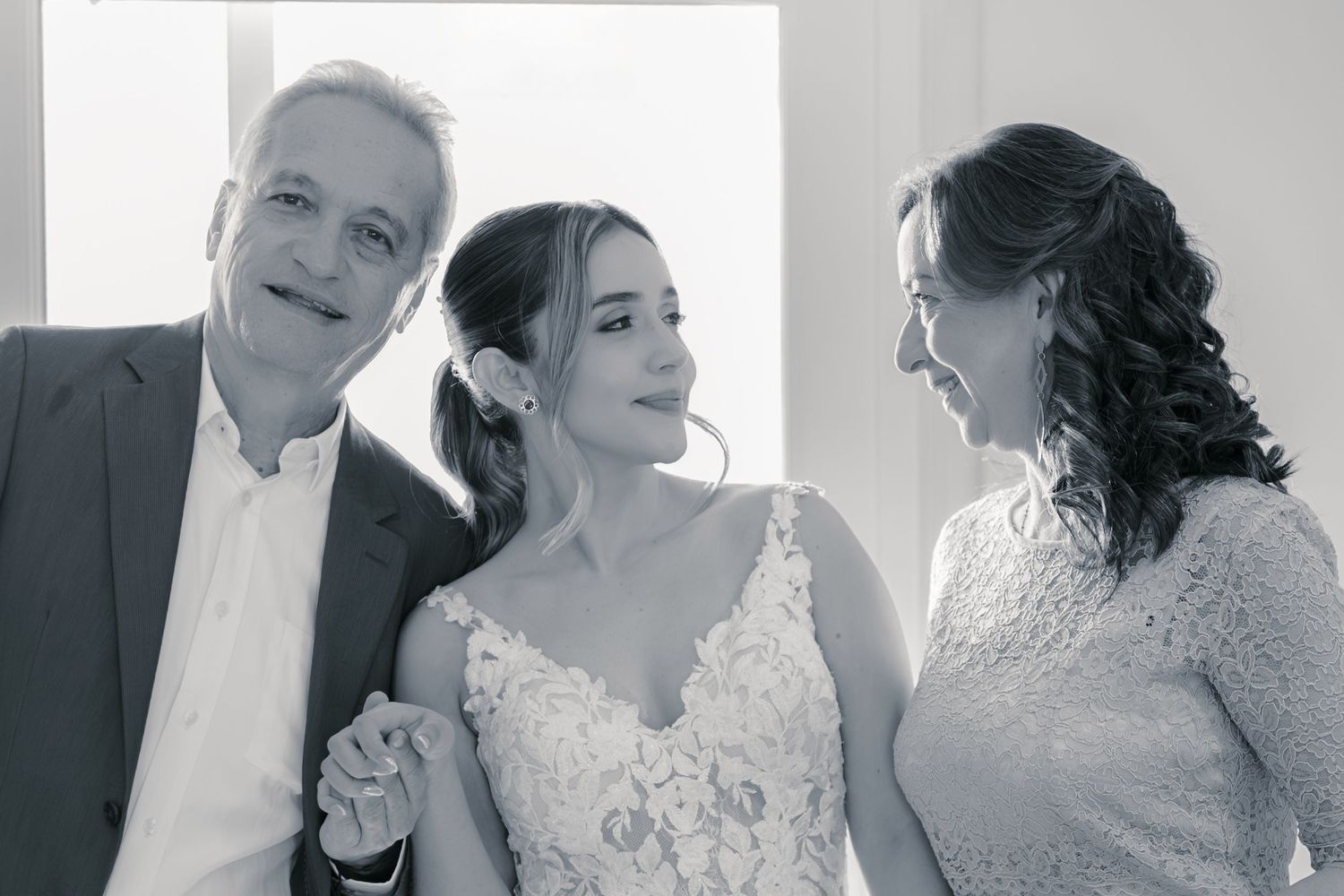 A series of black and white wedding photos showing intimate moments between a couple in formal attire.