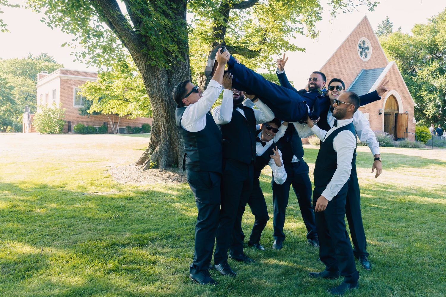 A sequence of black and white wedding photos showing dancing and celebration outdoors in a grassy setting.