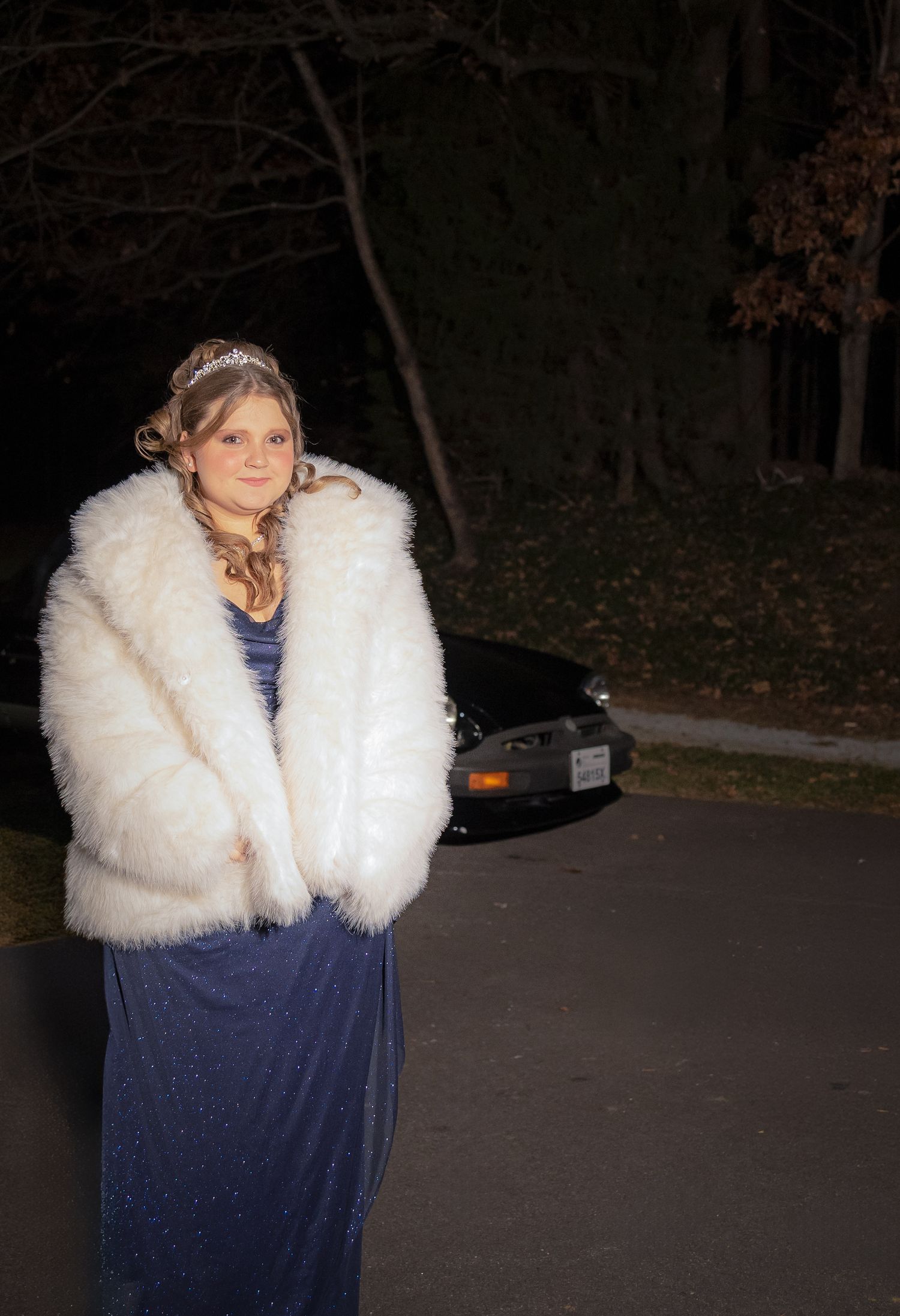 Evening portrait in white fur coat and blue dress.
