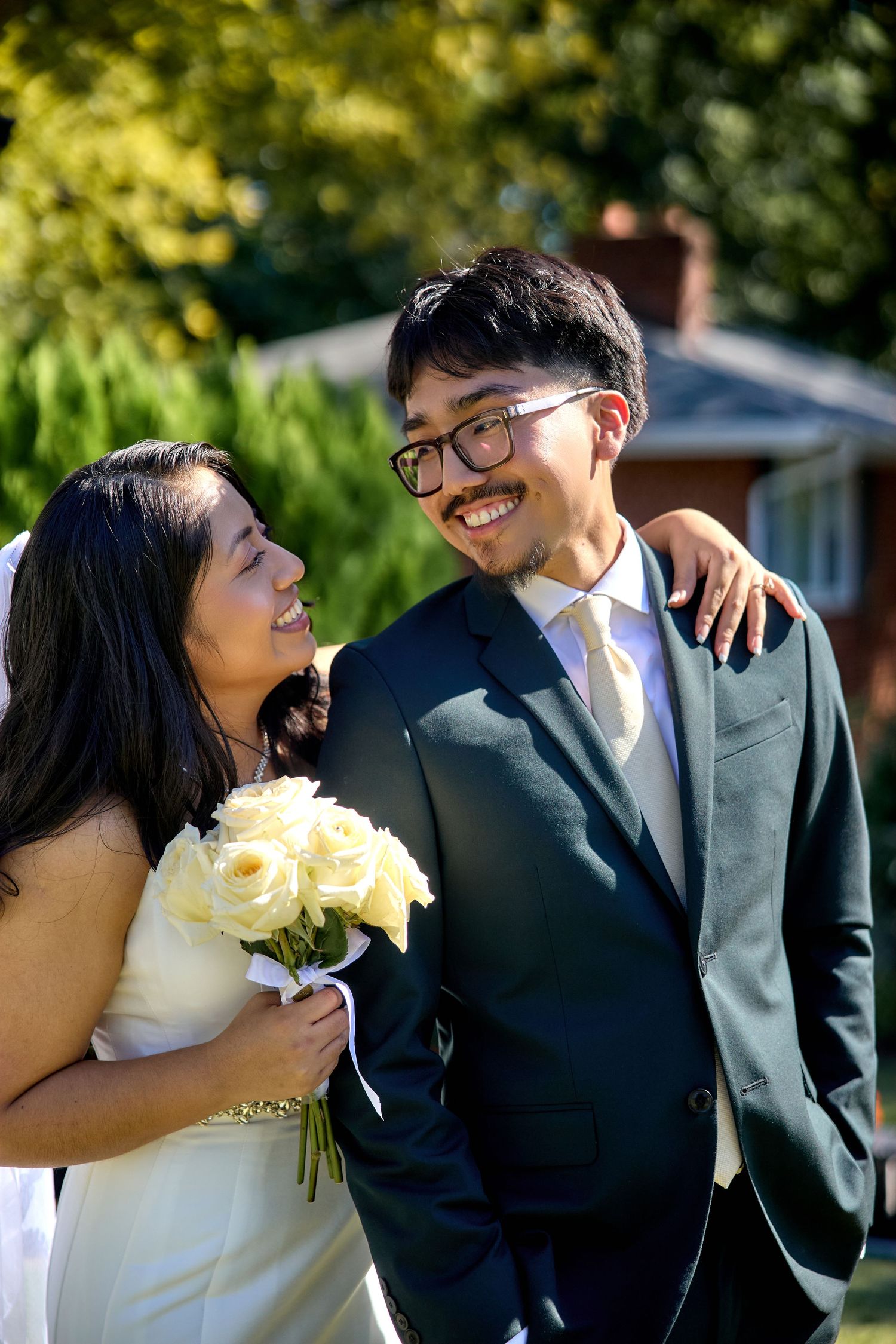 A series of romantic wedding photos showing a couple sharing intimate moments and laughter in an outdoor garden setting.