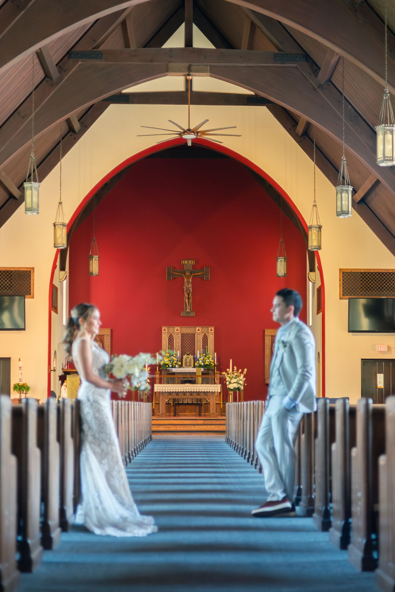 A sequence of photos showing a couple in wedding attire walking down a church aisle with blue carpet and wooden pews.