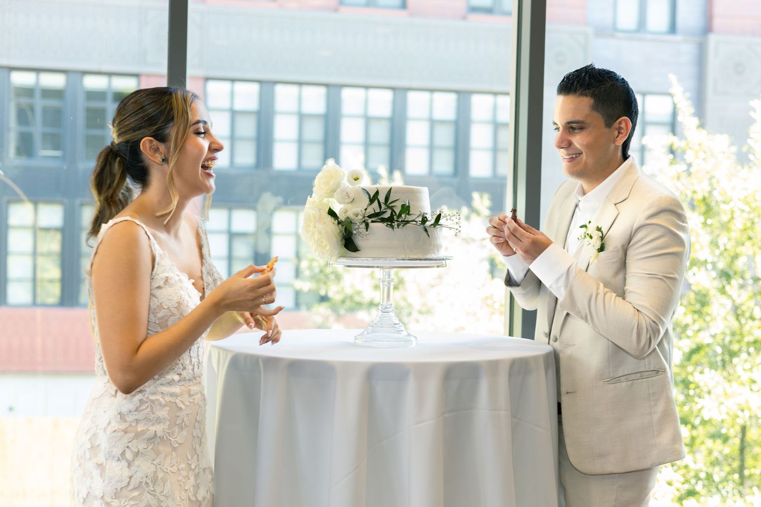 Celebratory dance moment captured in a bright modern venue with large windows.