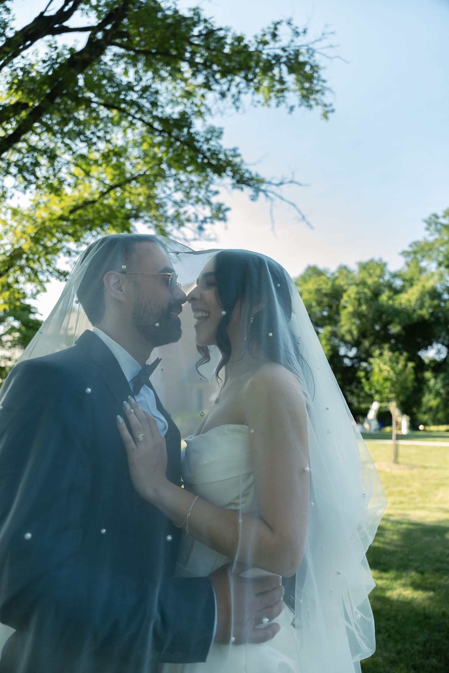 A tender kiss between newlyweds is captured in a sequence of four romantic outdoor photos with natural sunlight.