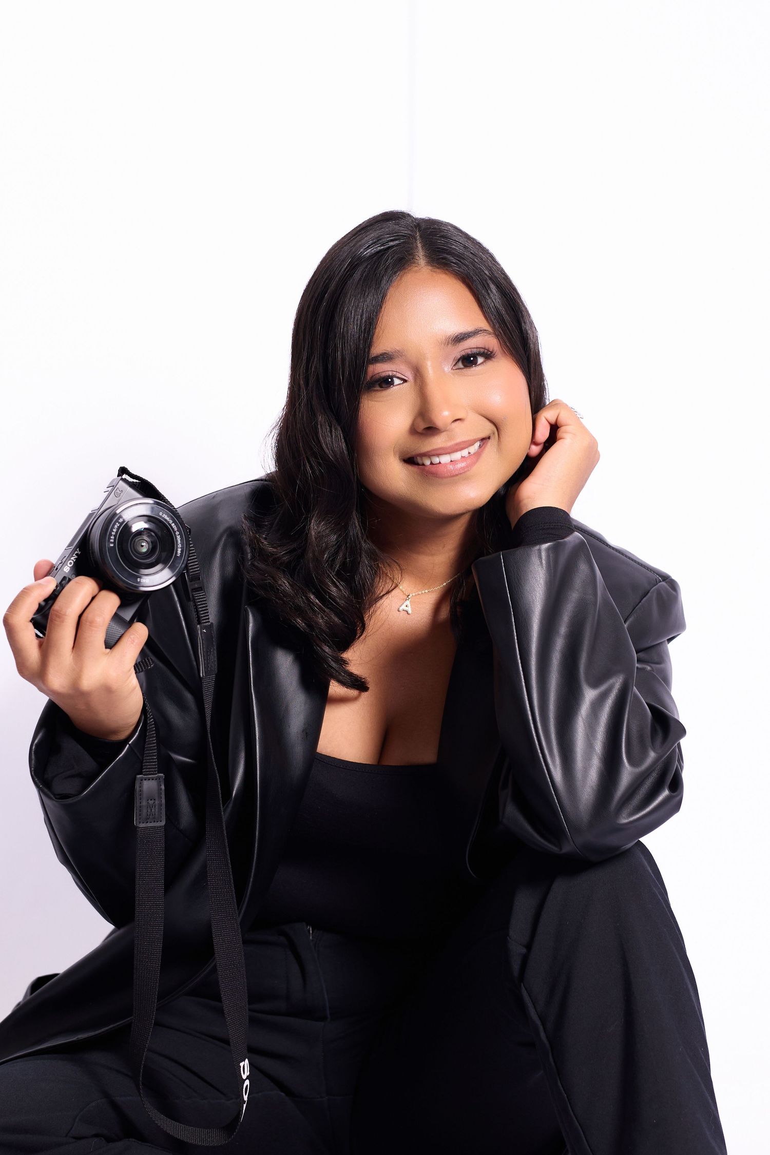 A series of lifestyle portraits showing someone in a black leather jacket holding a camera against a white backdrop.