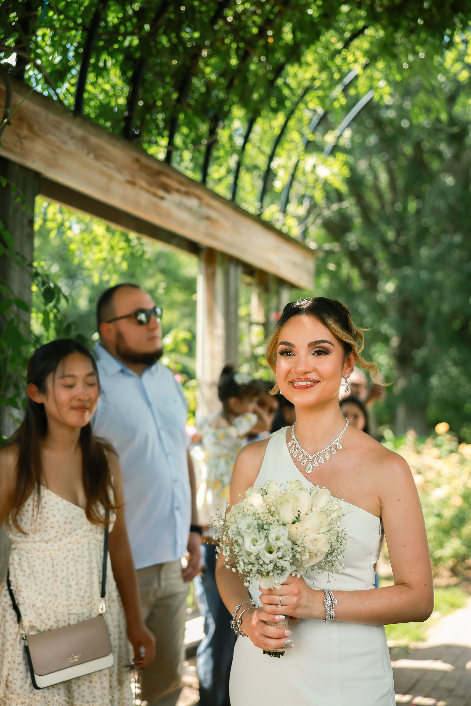 A joyful wedding celebration in a garden setting with guests and flowers.