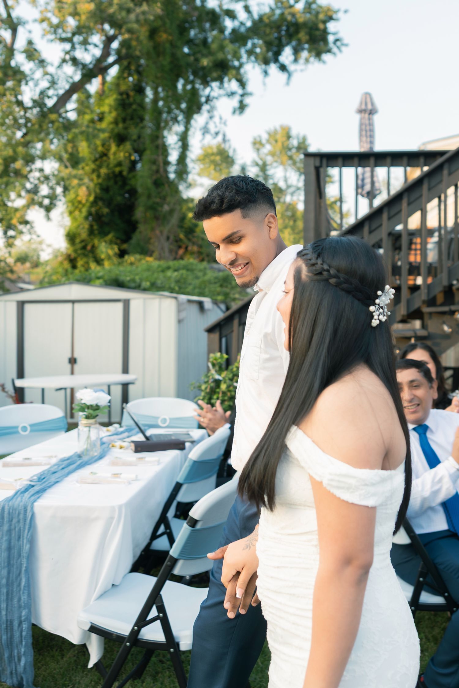 A sequence of wedding photos showing a couple signing their marriage certificate at an outdoor ceremony.