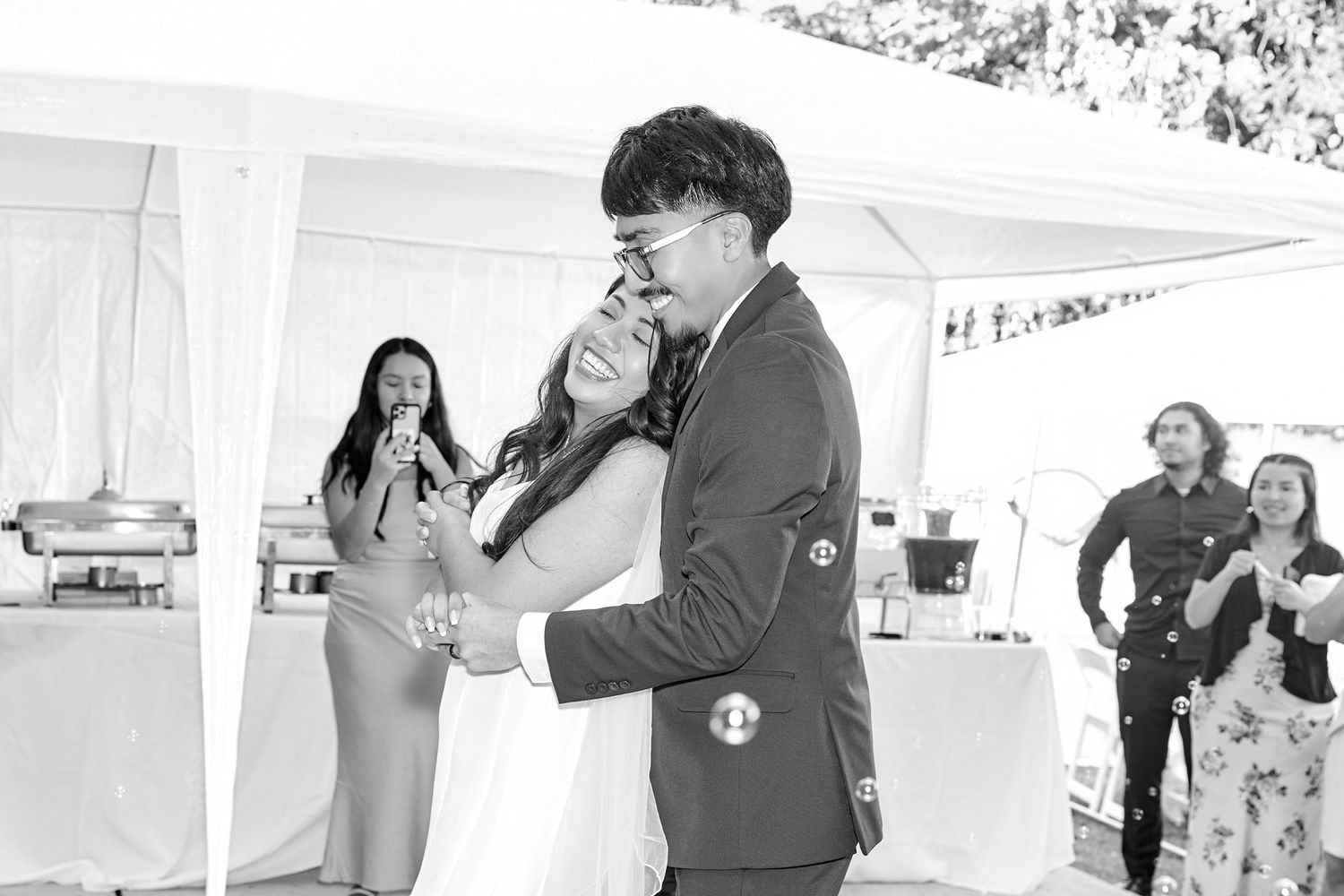 A series of black and white photos showing people in various casual and candid moments at an event or gathering.