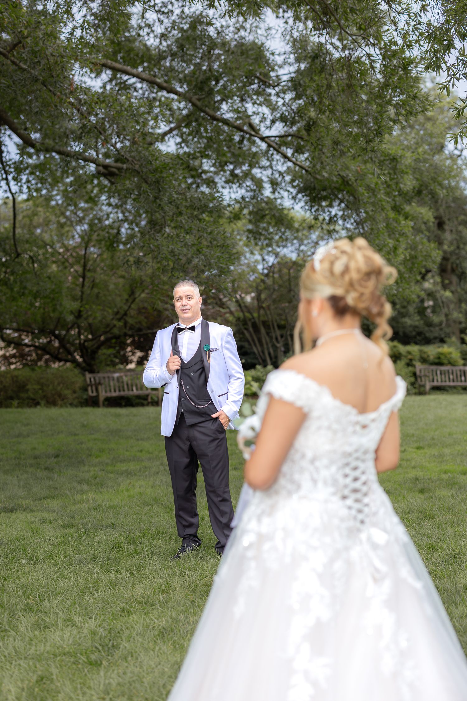 A sequence of wedding photos shows two people sharing an emotional first look moment in a grassy outdoor setting.