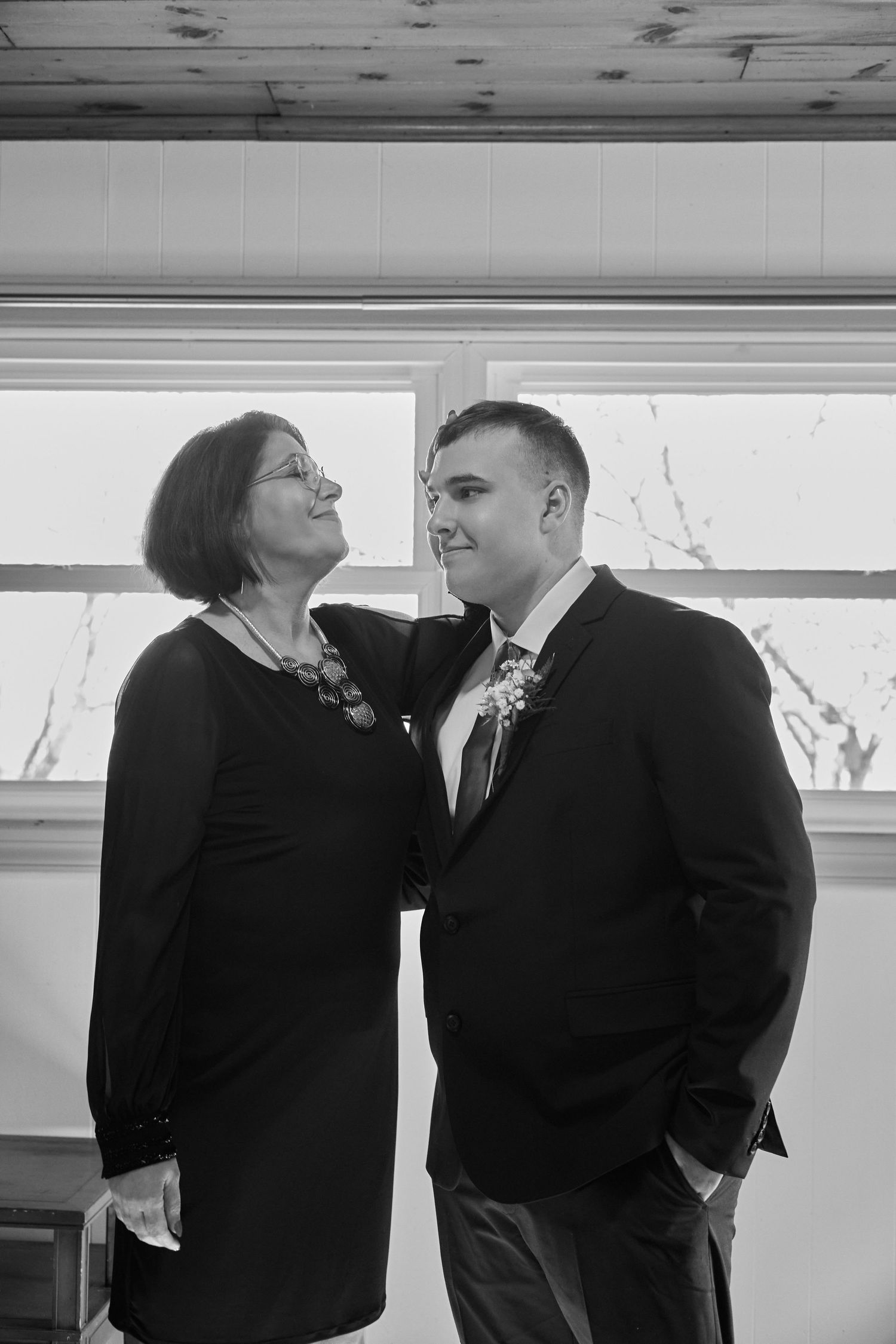 Black and white photo series showing a couple sharing intimate moments and laughter during a romantic photoshoot.