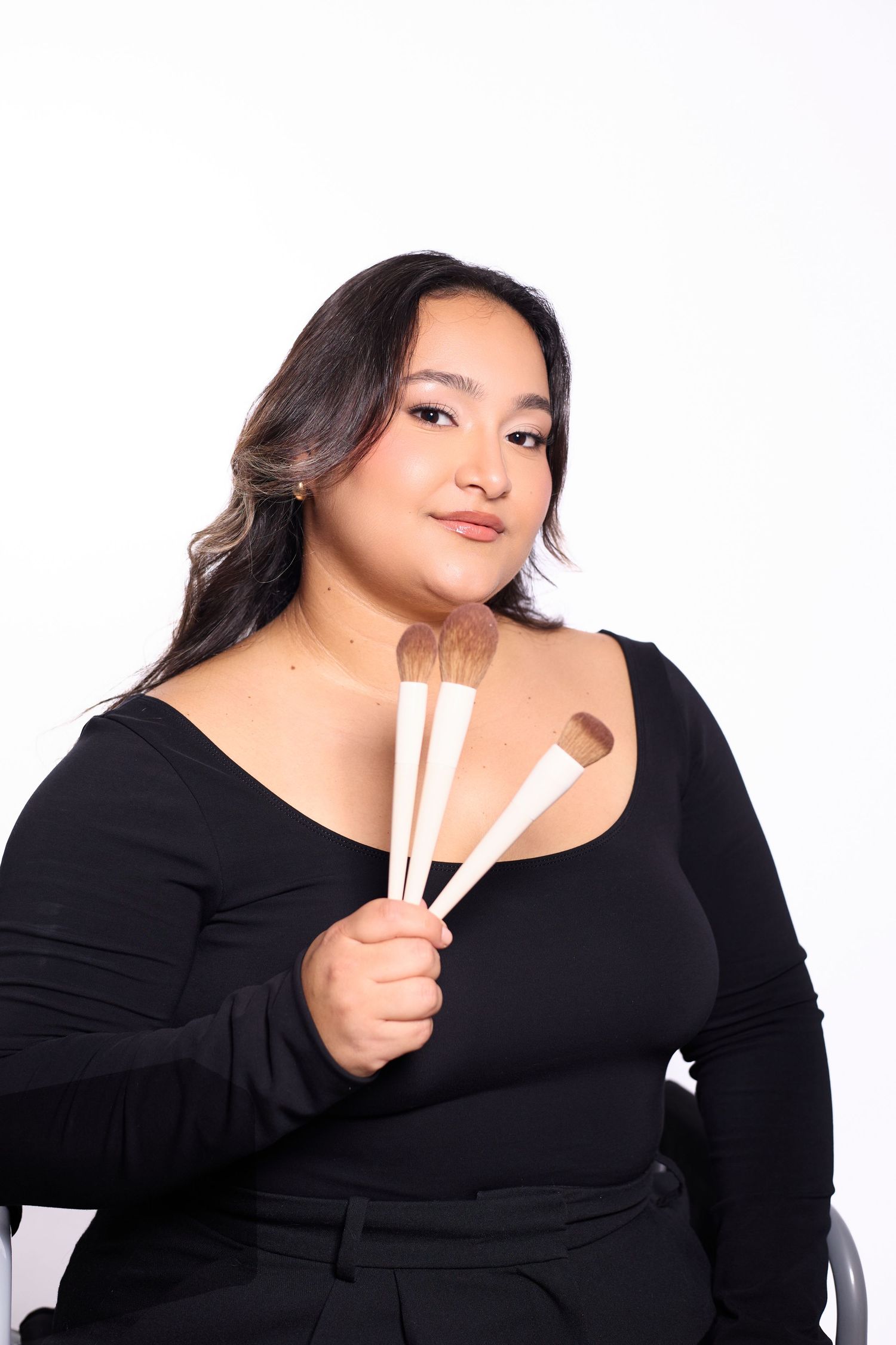 Professional portrait series showing poses with chopsticks against white background in black top.