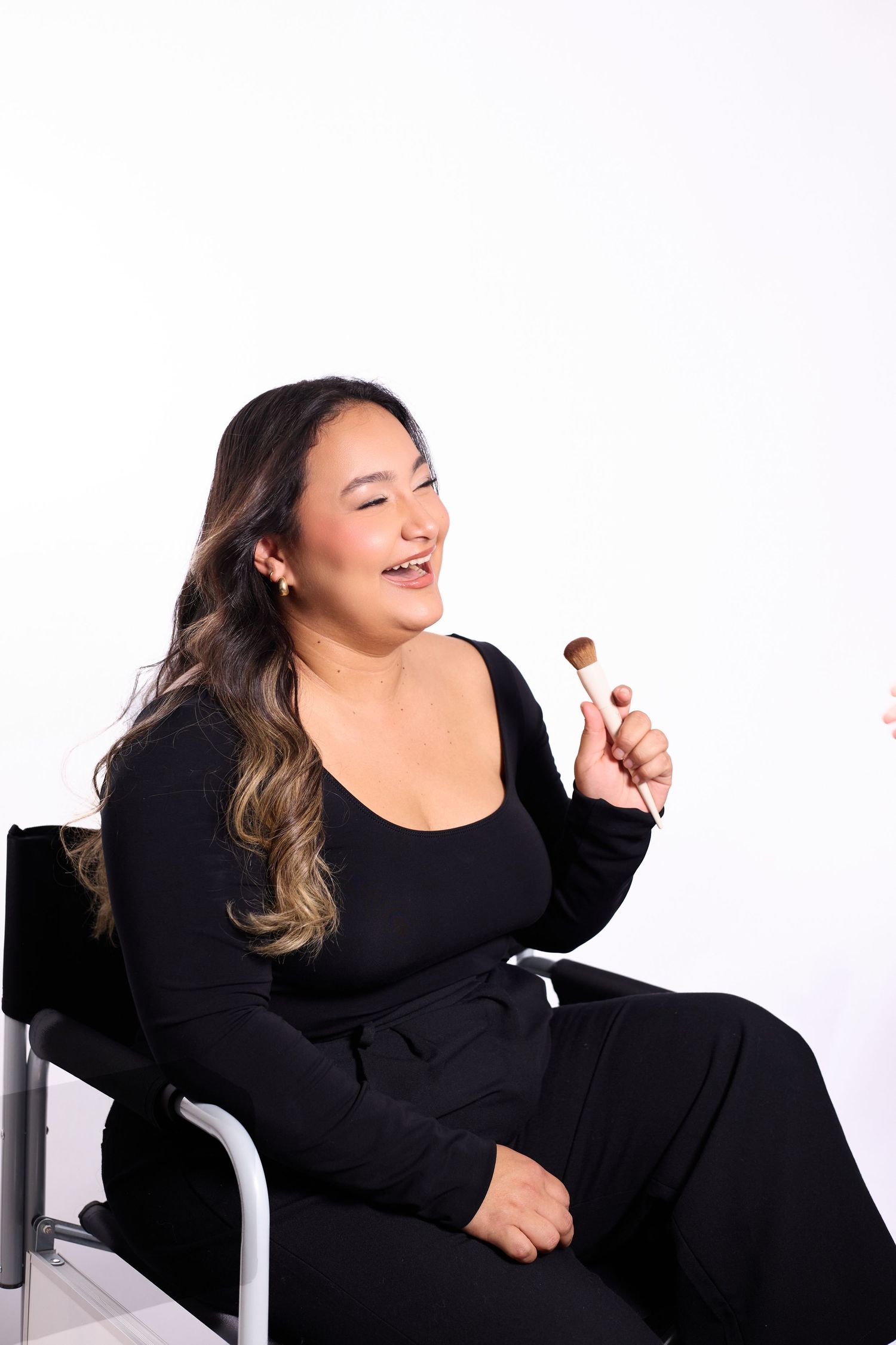 Woman in black dress poses expressively against white background in four dynamic shots.