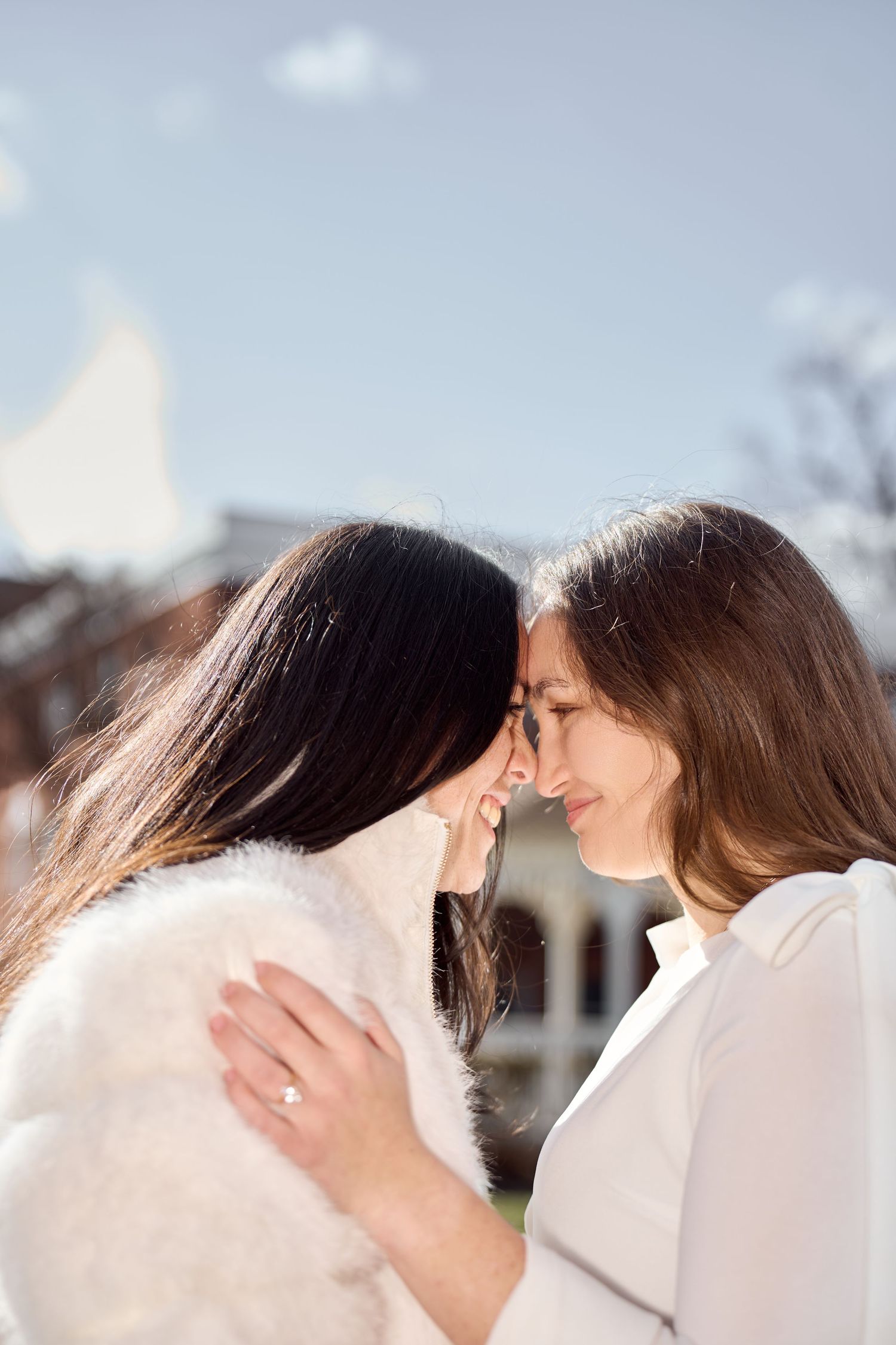 A romantic moment captured in a series of close-up shots showing two people in white outfits against a blurred background.