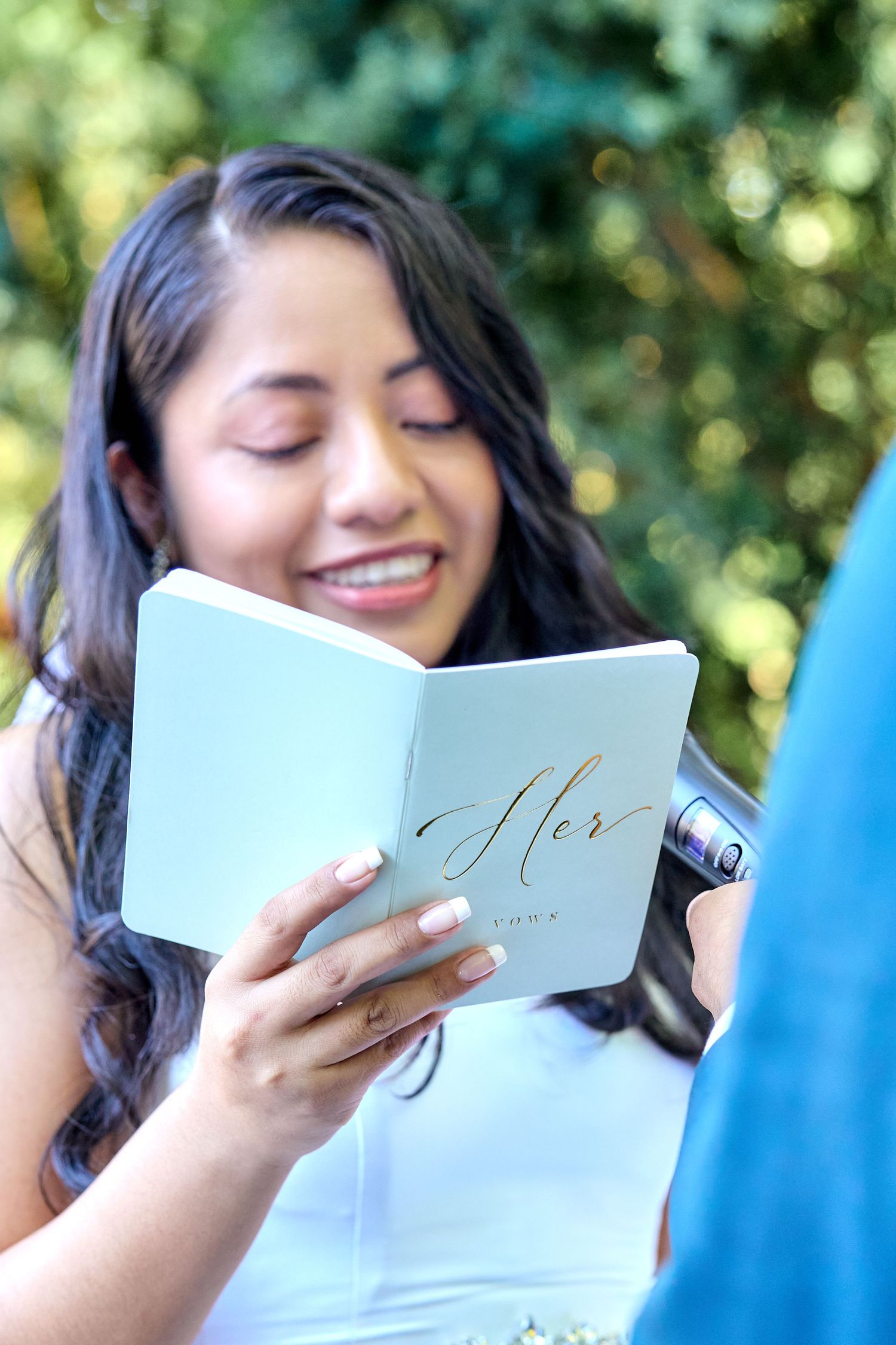 Series of photos showing someone reading a light blue card or letter with a joyful expression outdoors.
