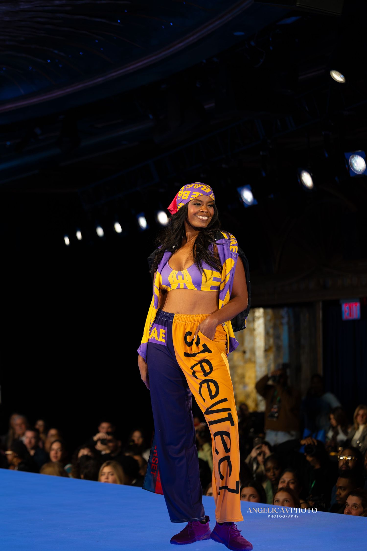 Athletic inspired runway look featuring yellow and purple sportswear ensemble.