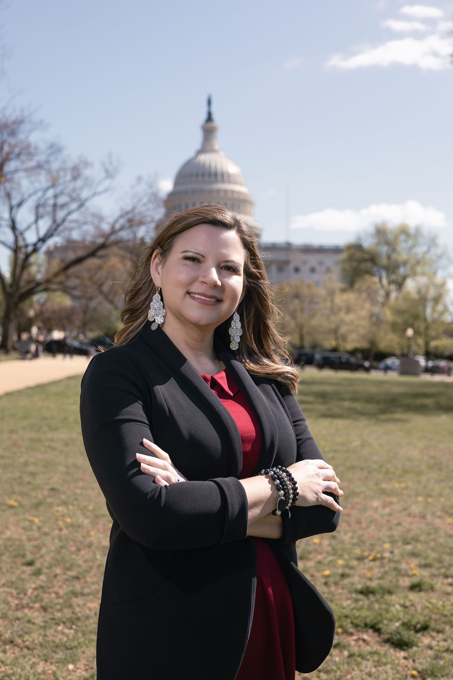 Professional photo taken on the National Mall with the United States Capitol dome visible in the background on a sunny day.