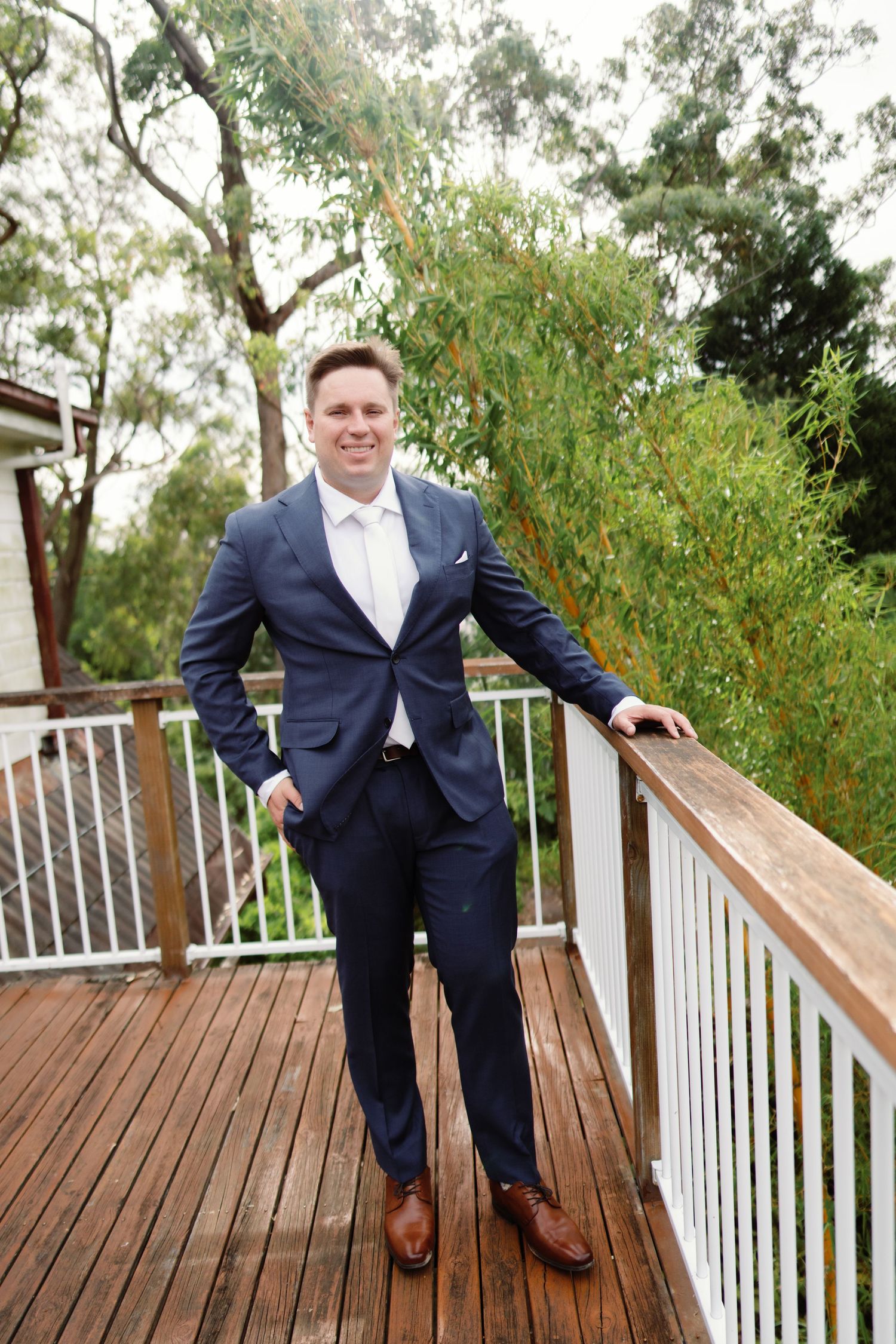 A series of fun jumping poses on a wooden deck in formal attire.