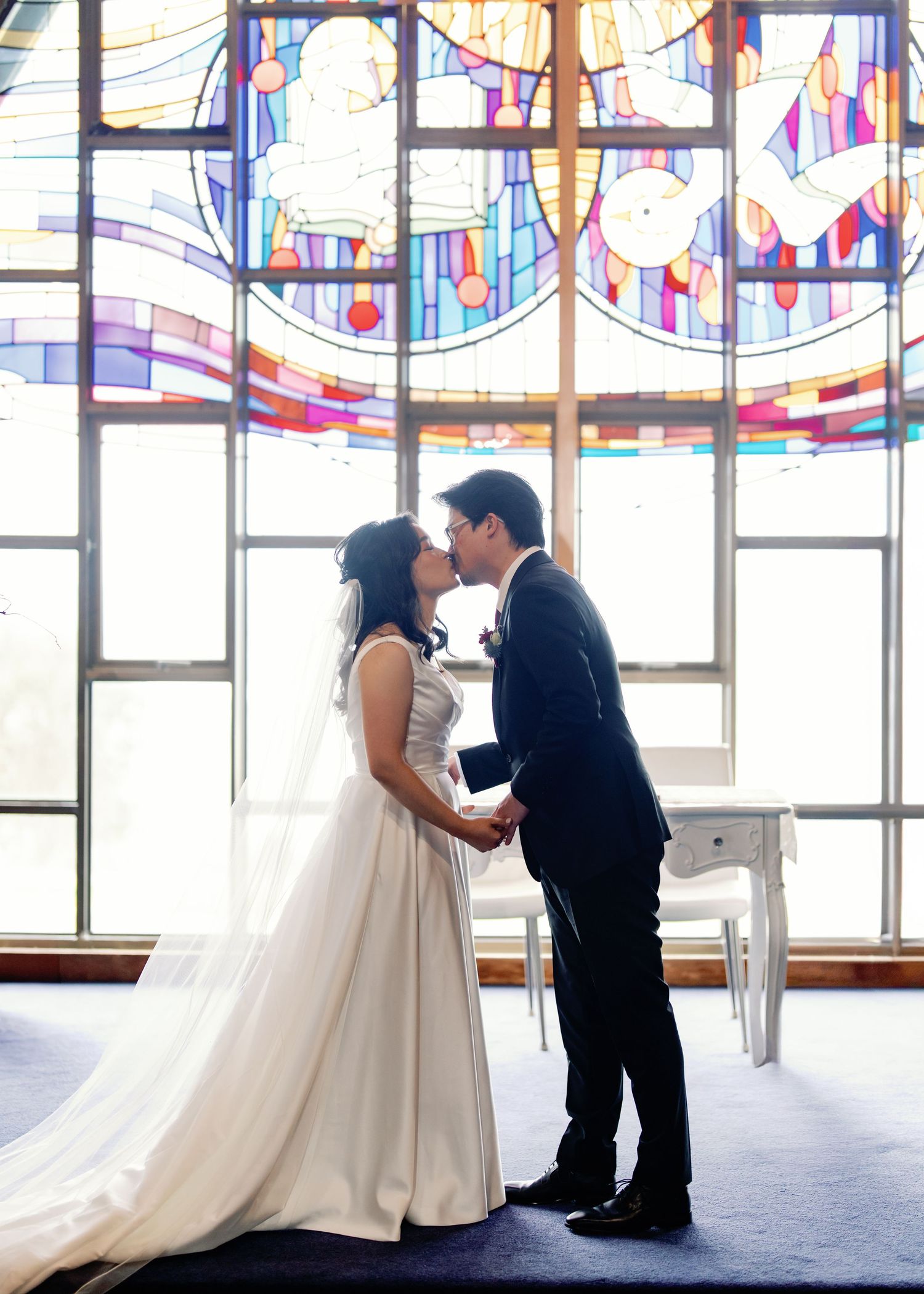 A sequence of romantic wedding moments showing a couple in formal attire sharing tender moments under decorative bunting.
