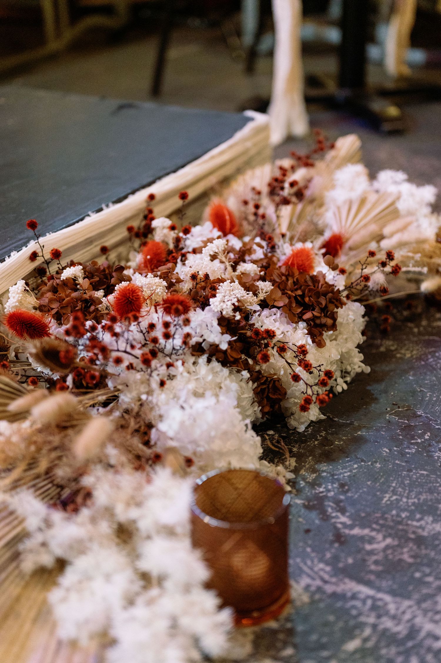 Close-up sequence of white powder being scattered across a dark surface with red accents.