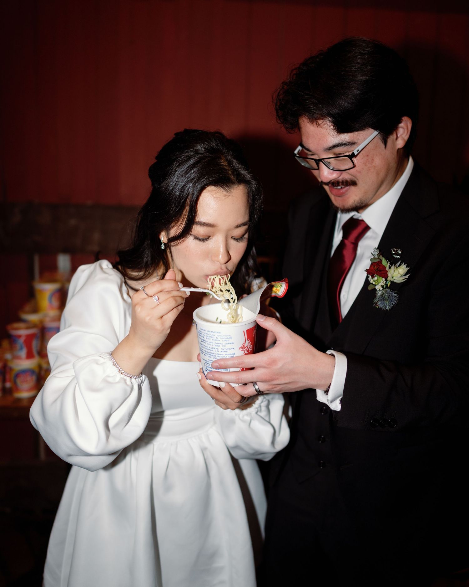 Wedding couple sharing dessert together in formal attire.